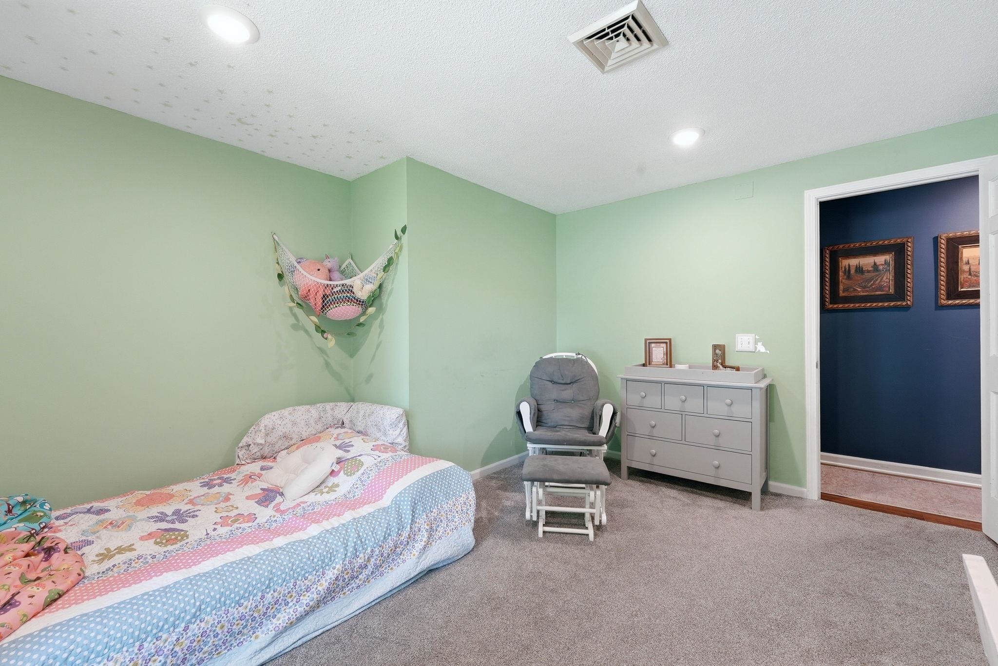 Spacious room with plush carpeting, recessed lighting, and a neutral ceiling