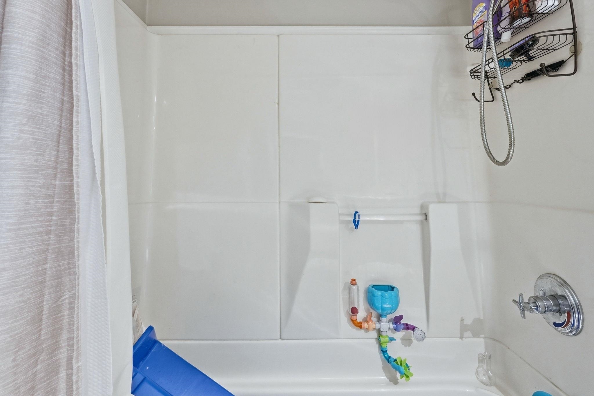 White fiberglass tub and shower combination with a bright white finish