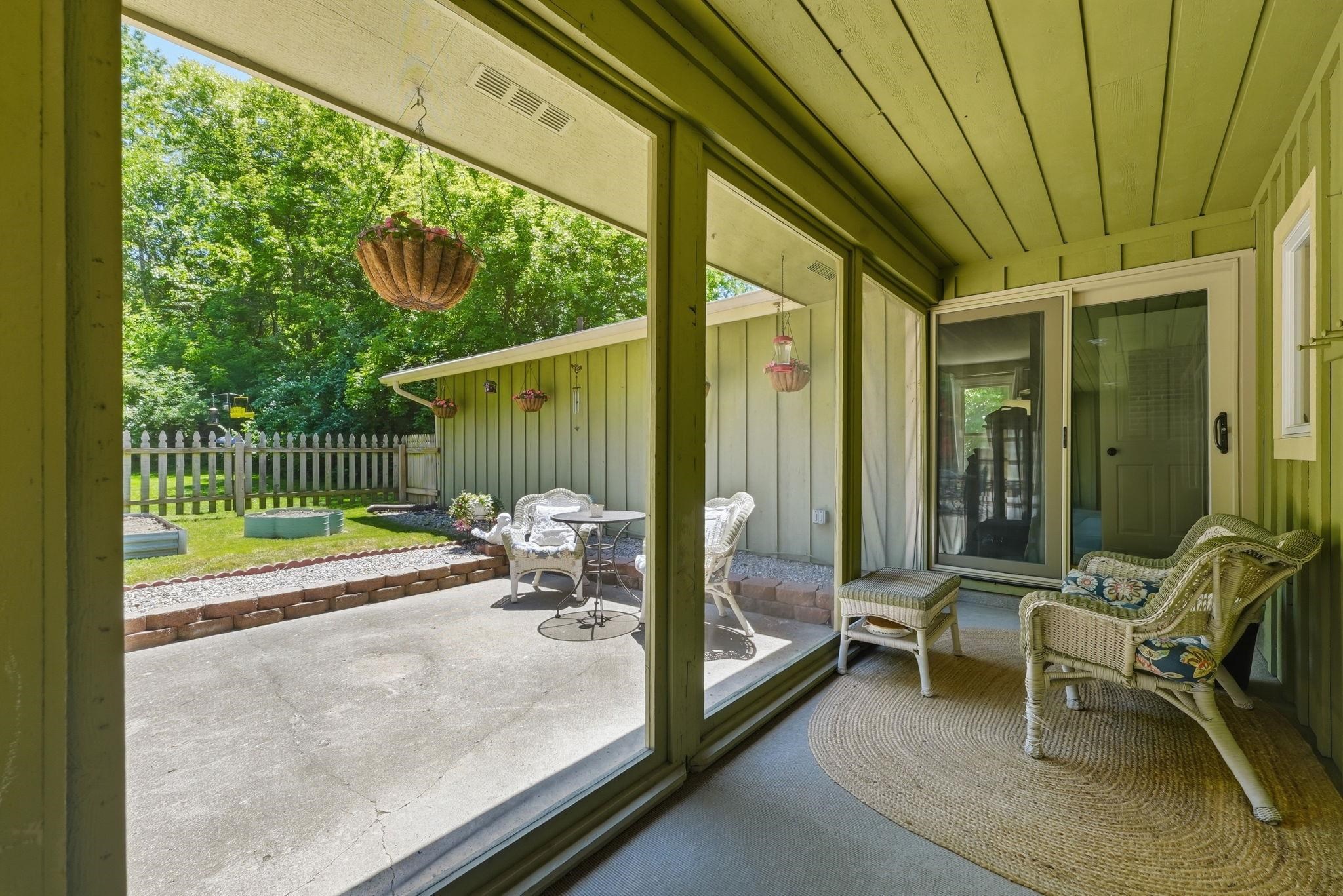 Covered patio featuring a sliding glass door, beadboard ceiling, and direct access to an outdoor concrete patio
