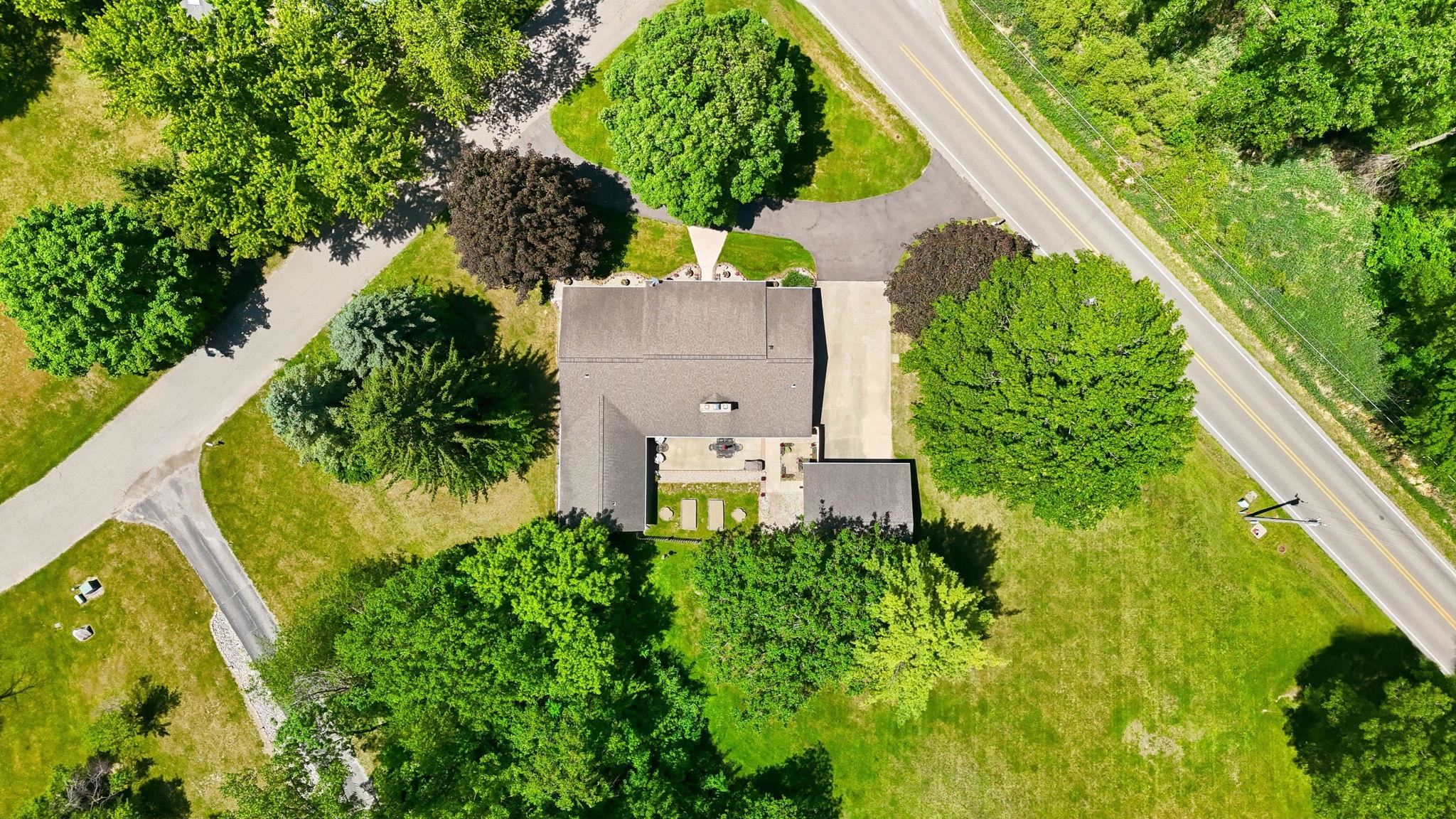 Single-story residence set amidst mature trees and expansive lawns