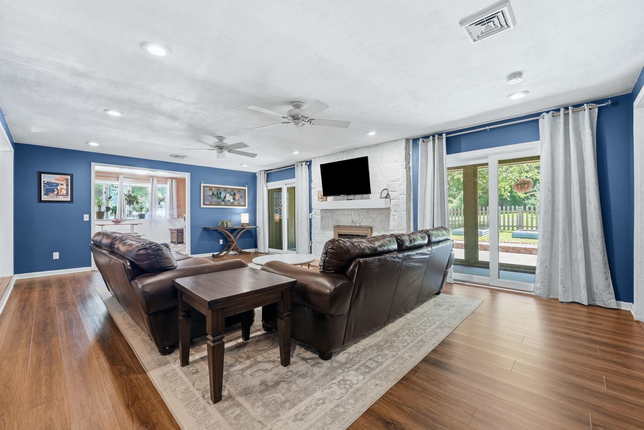 Spacious interior featuring wood-finish flooring, recessed lighting, and dual ceiling fans