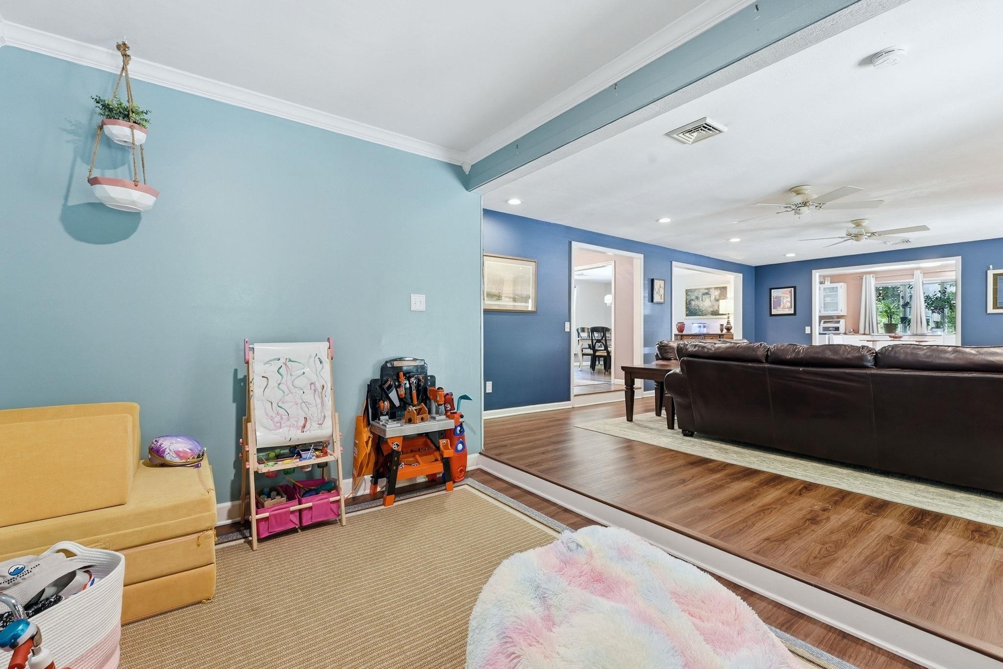 Expansive interior featuring wood-finish flooring, recessed lighting, and crown molding