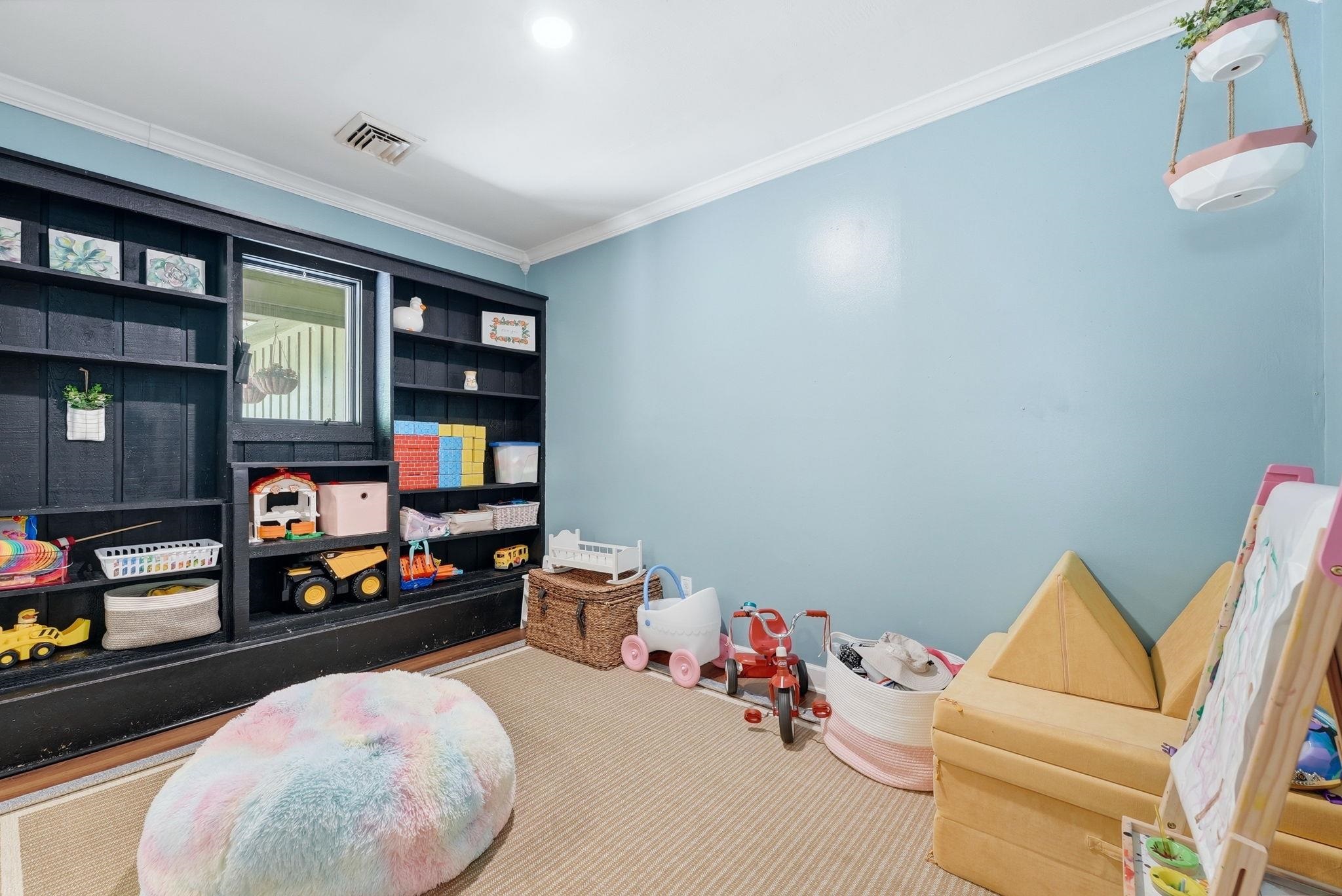 Built-in black shelving system with a central window