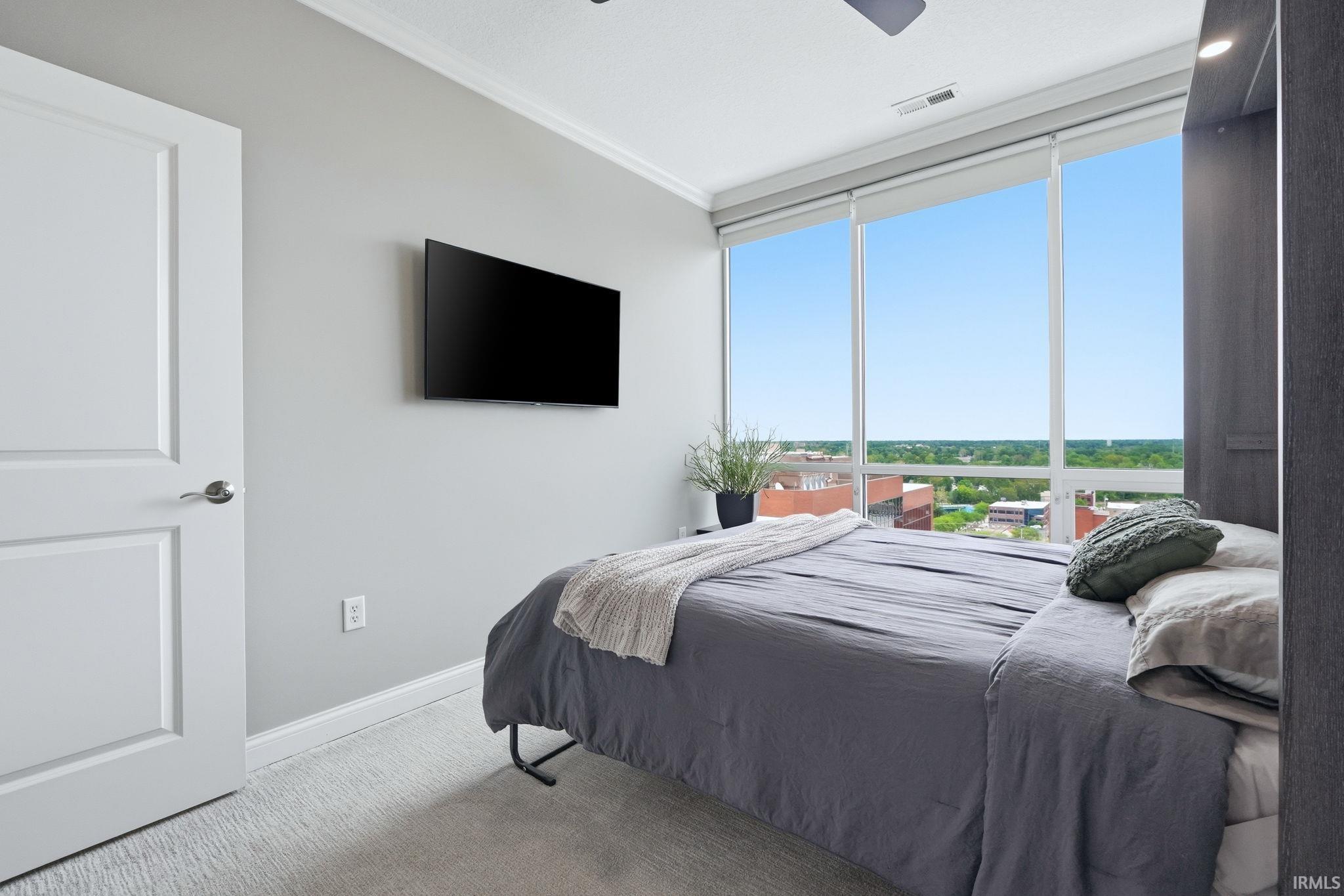Floor-to-ceiling windows with roller shades