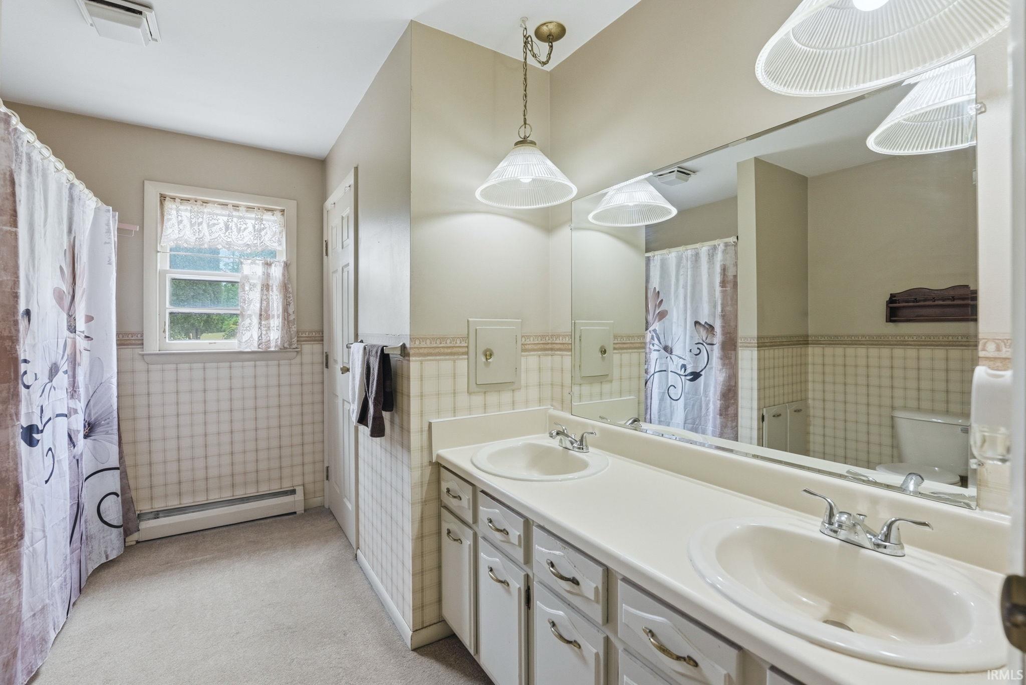 Dual vanity with integrated sinks, ample countertop space, and under-cabinet storage