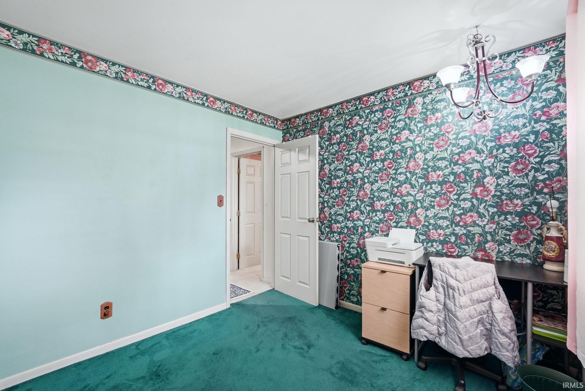Interior room featuring a floral wallpaper accent wall and coordinating wallpaper border
