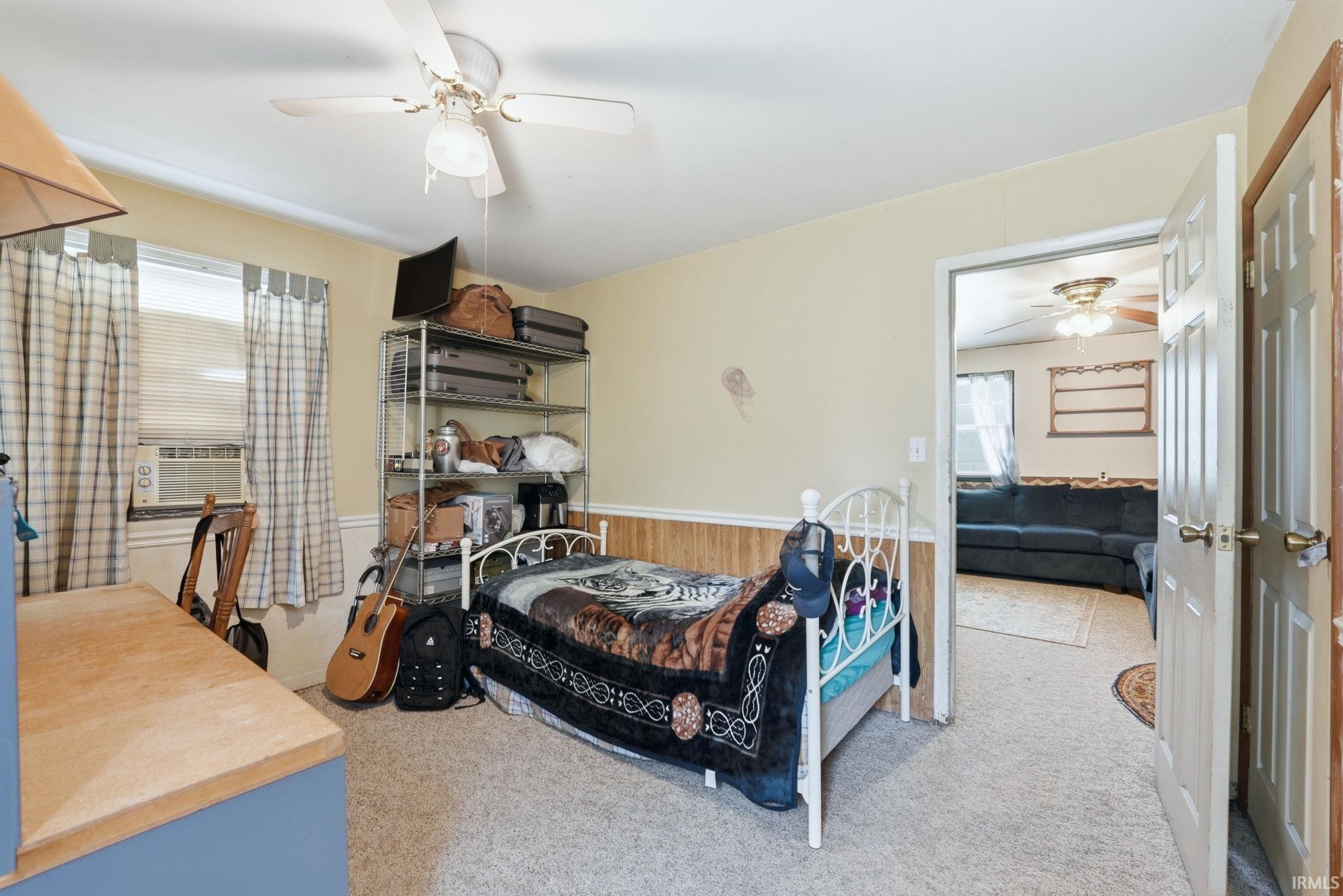 Carpeted room with a ceiling fan