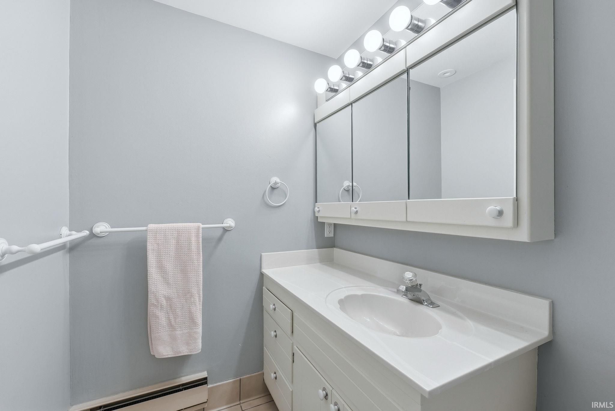 Bathroom vanity featuring a built-in sink and white countertop