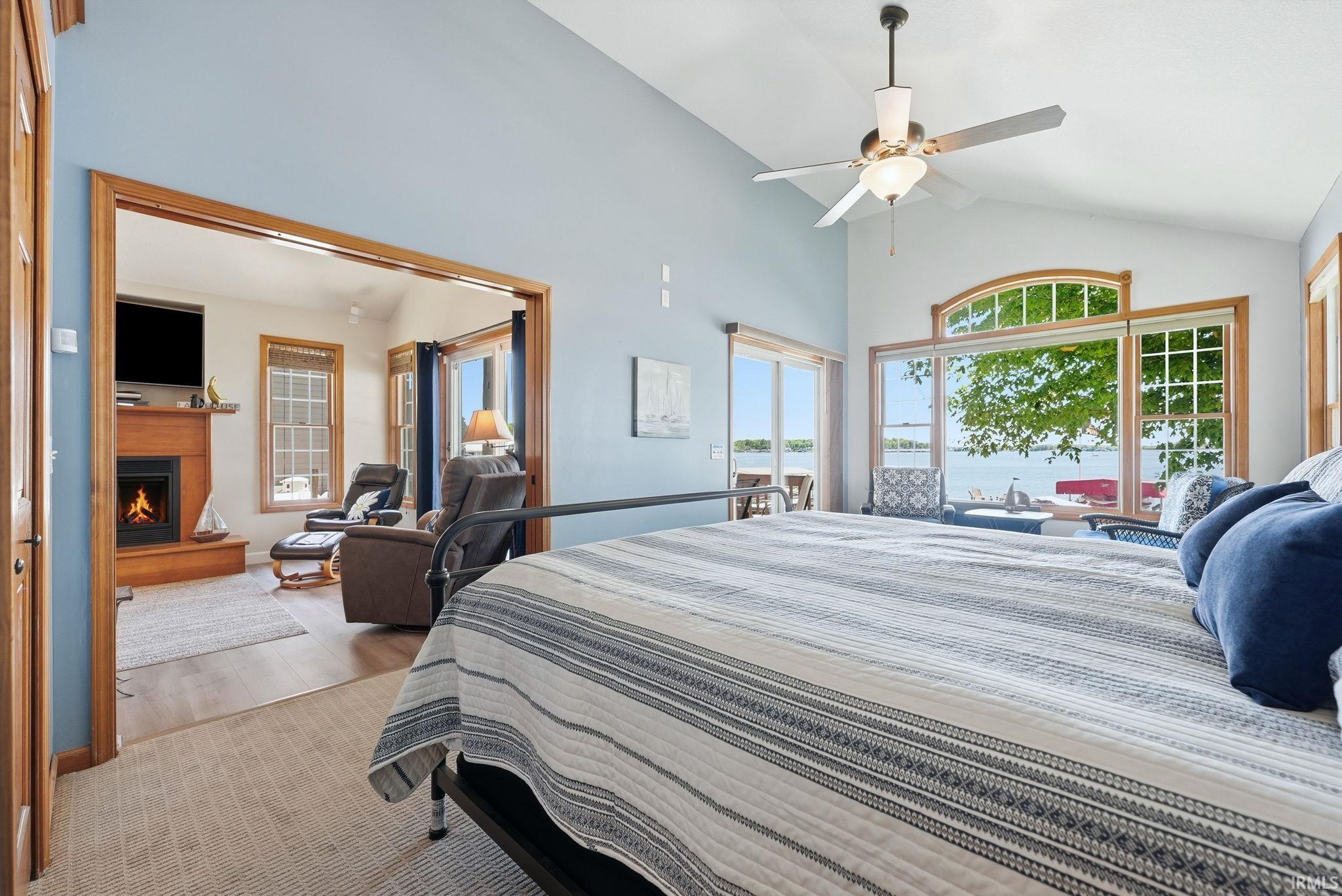 Vaulted ceiling room with expansive windows offering water scenery