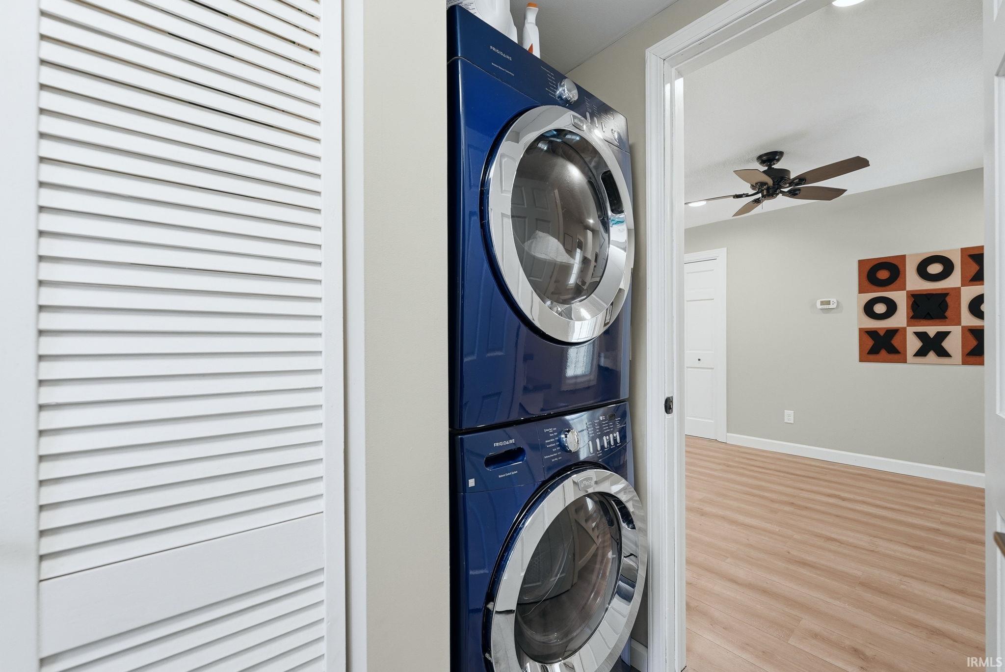 Dedicated laundry area featuring a stacked washer and dryer unit
