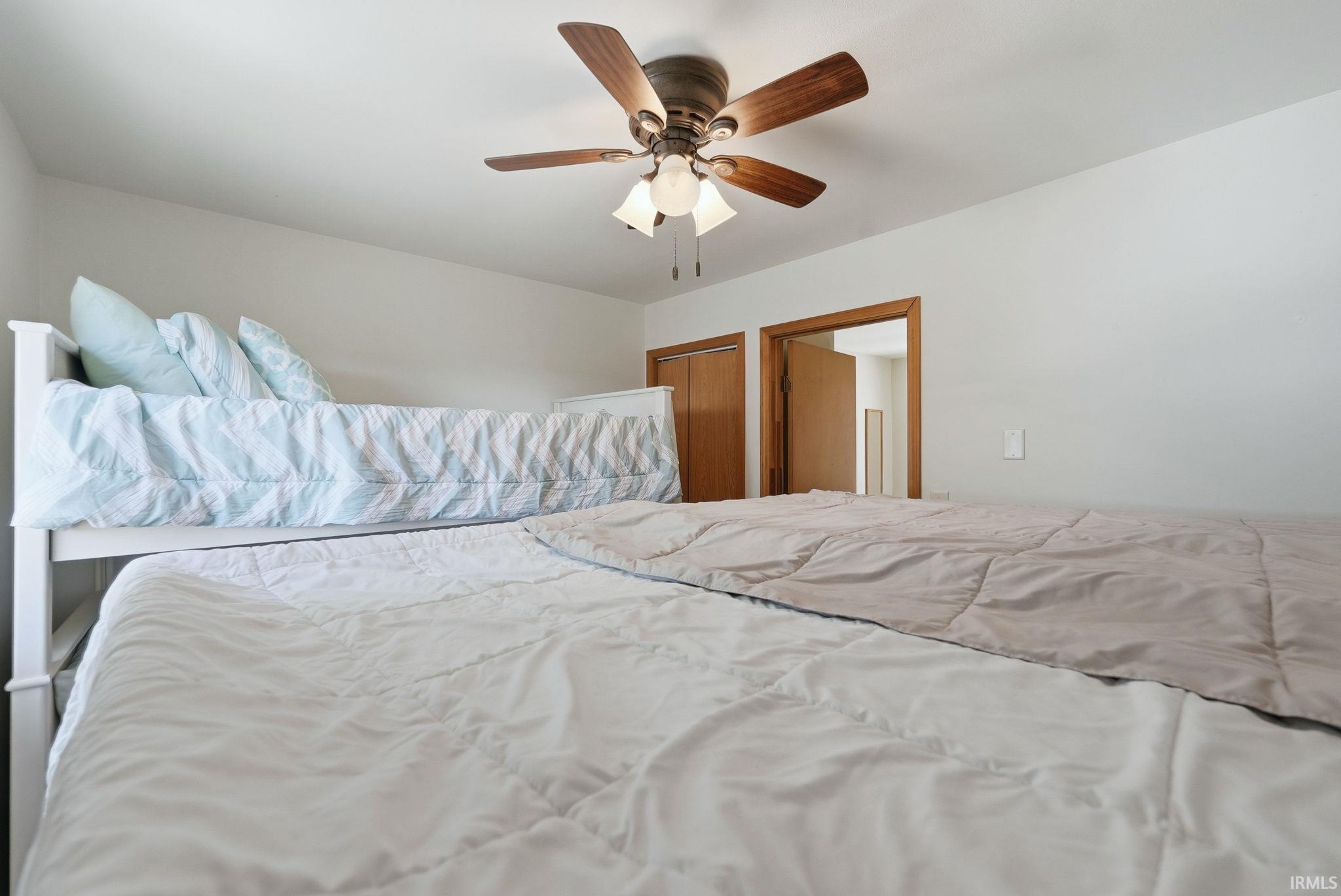 Room featuring light-colored walls and a ceiling fan with integrated lighting