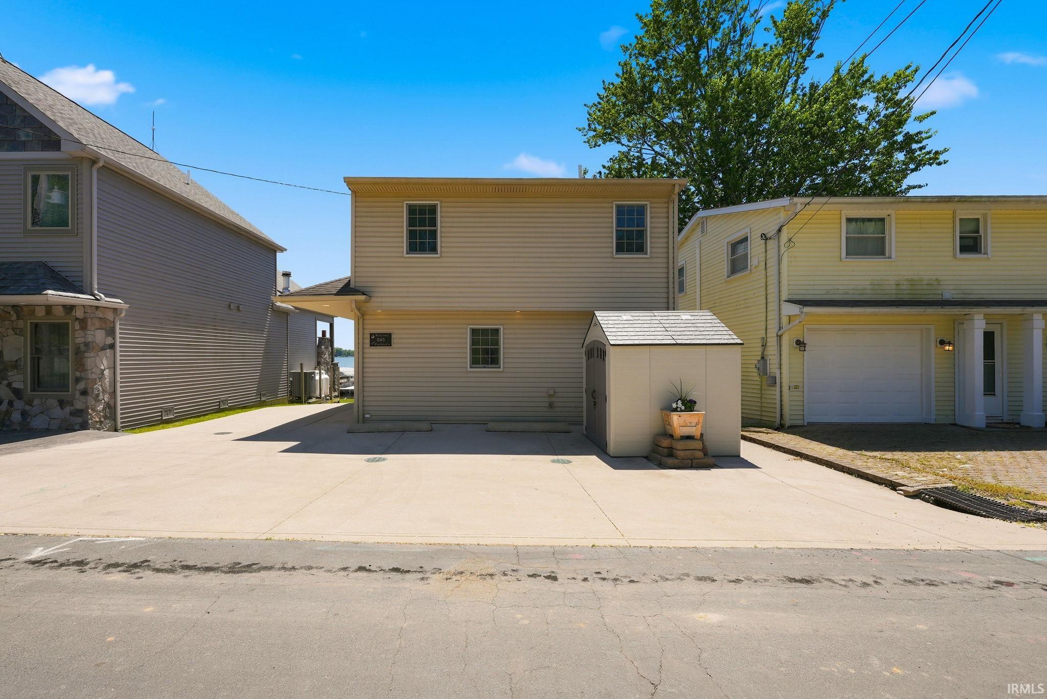 Two-story property with light-colored siding