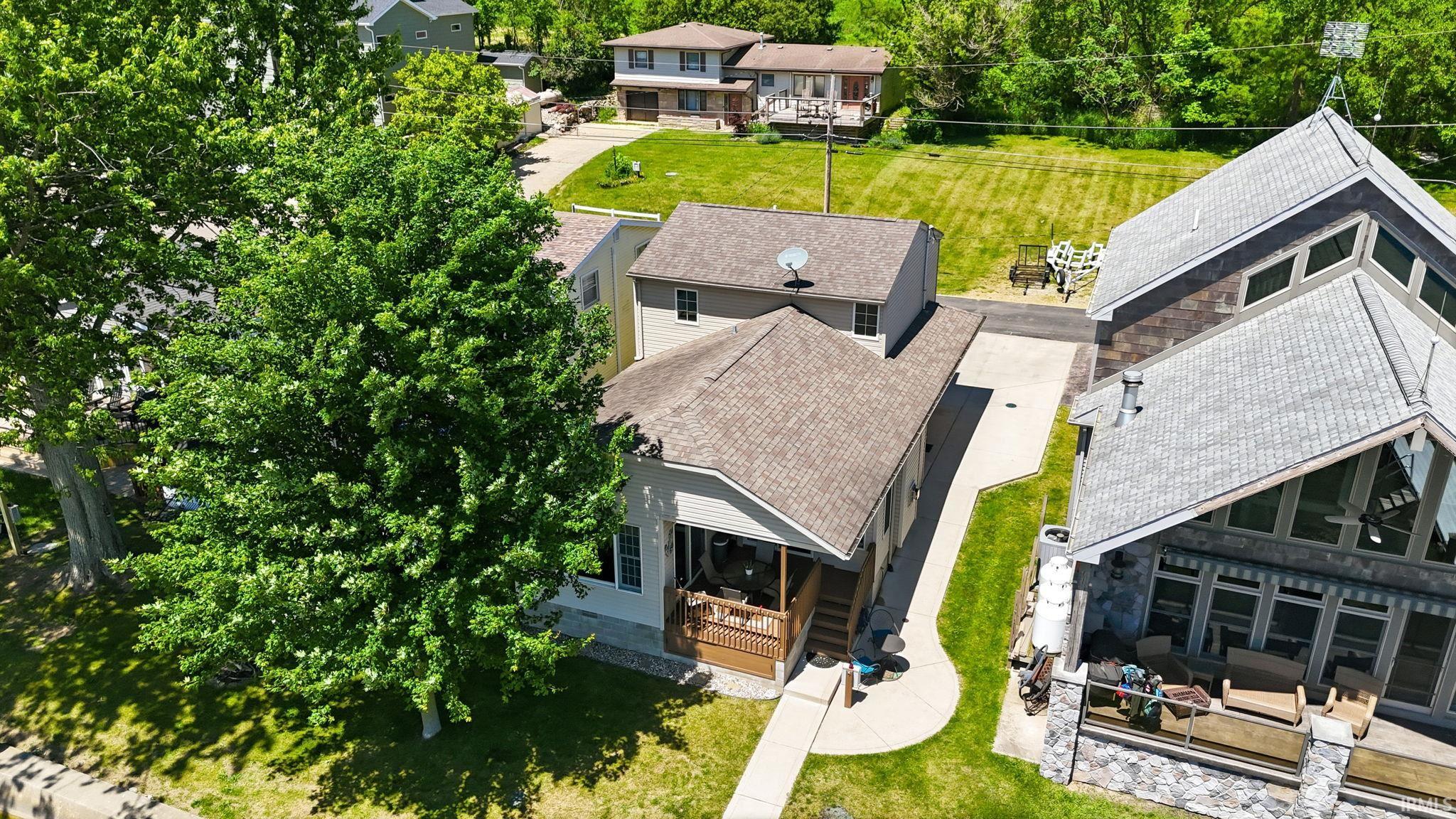 Two-story residence with a covered front porch featuring wooden railings