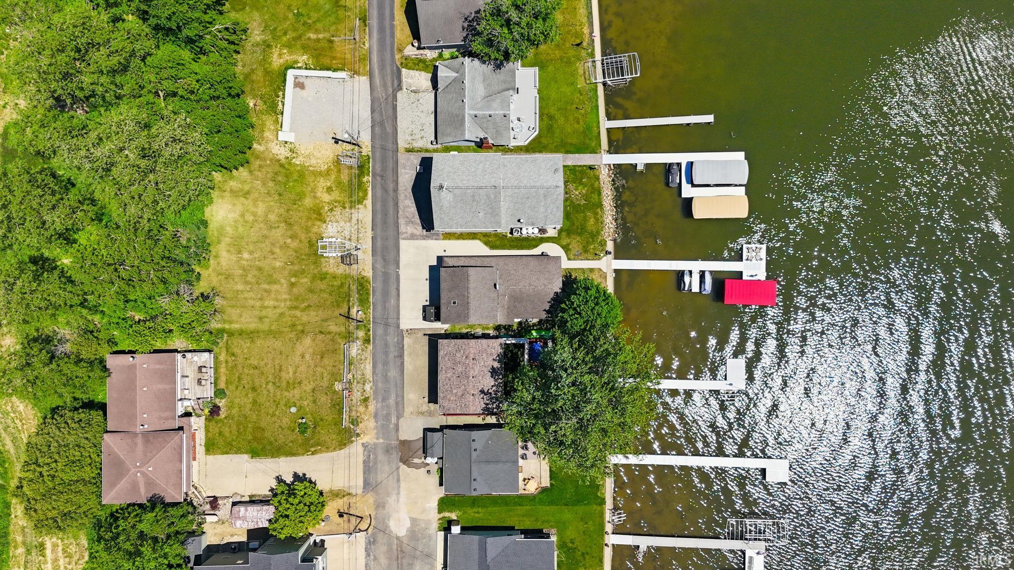 Waterfront properties featuring multiple docks, direct water access, and established landscaping