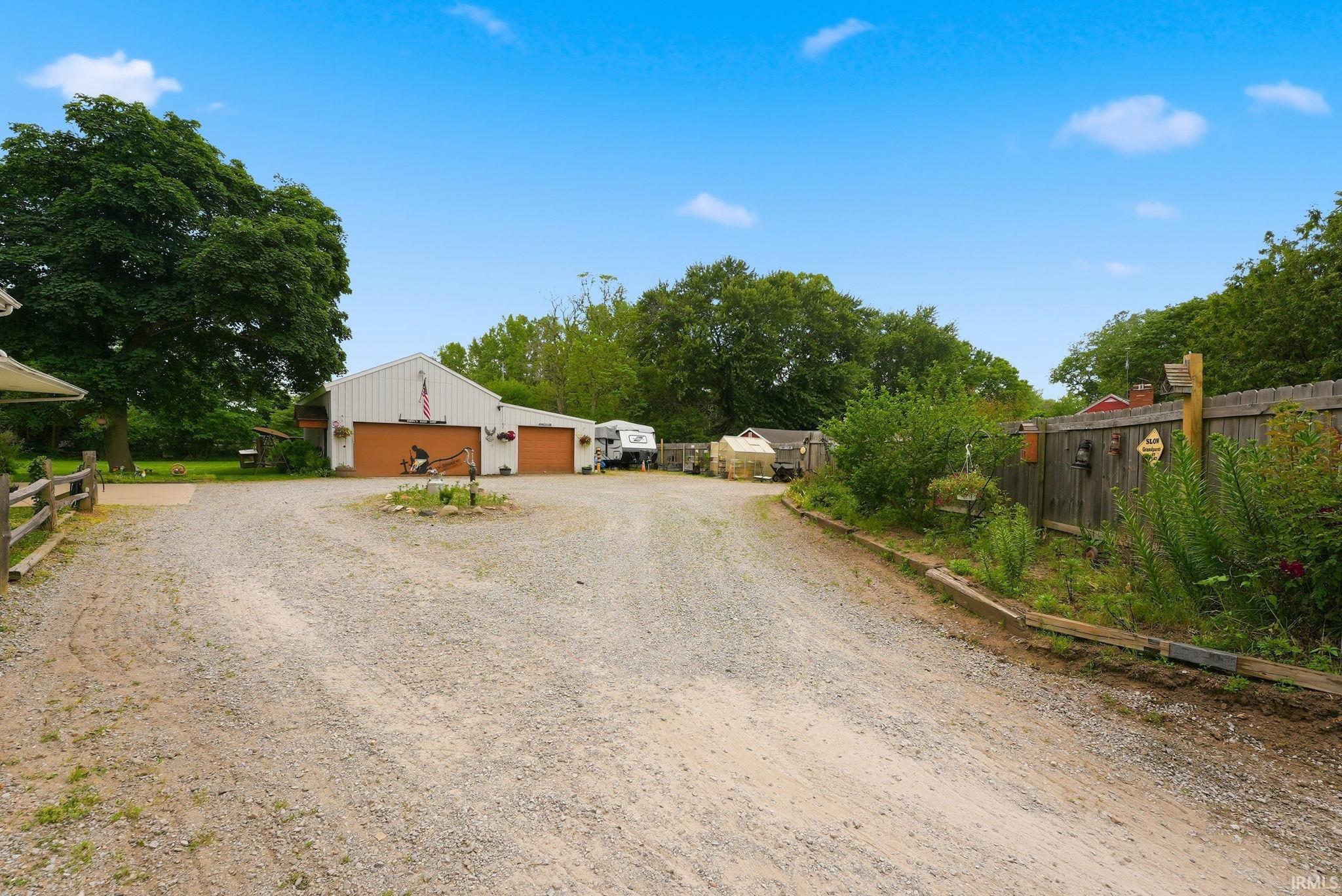 Spacious gravel driveway offering ample parking