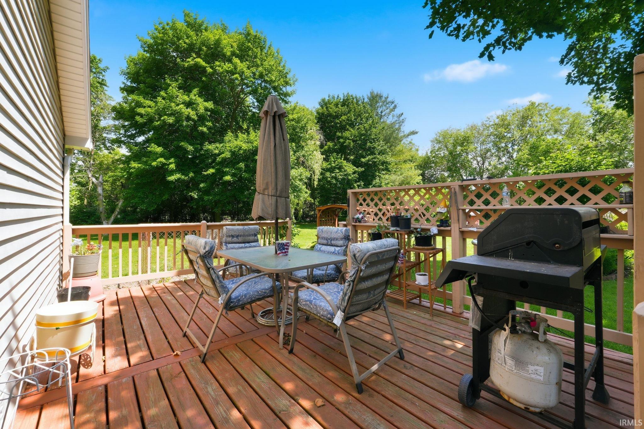 Exterior wood plank decking with wood railing and lattice accents