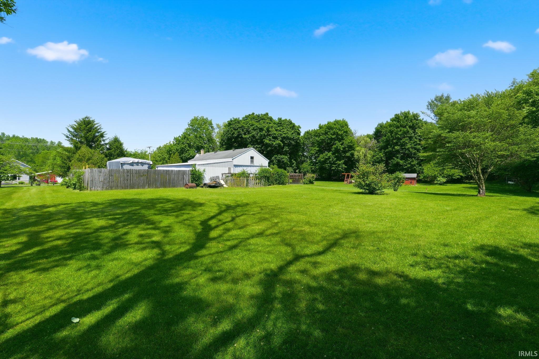 Expansive green lawn with dappled sunlight