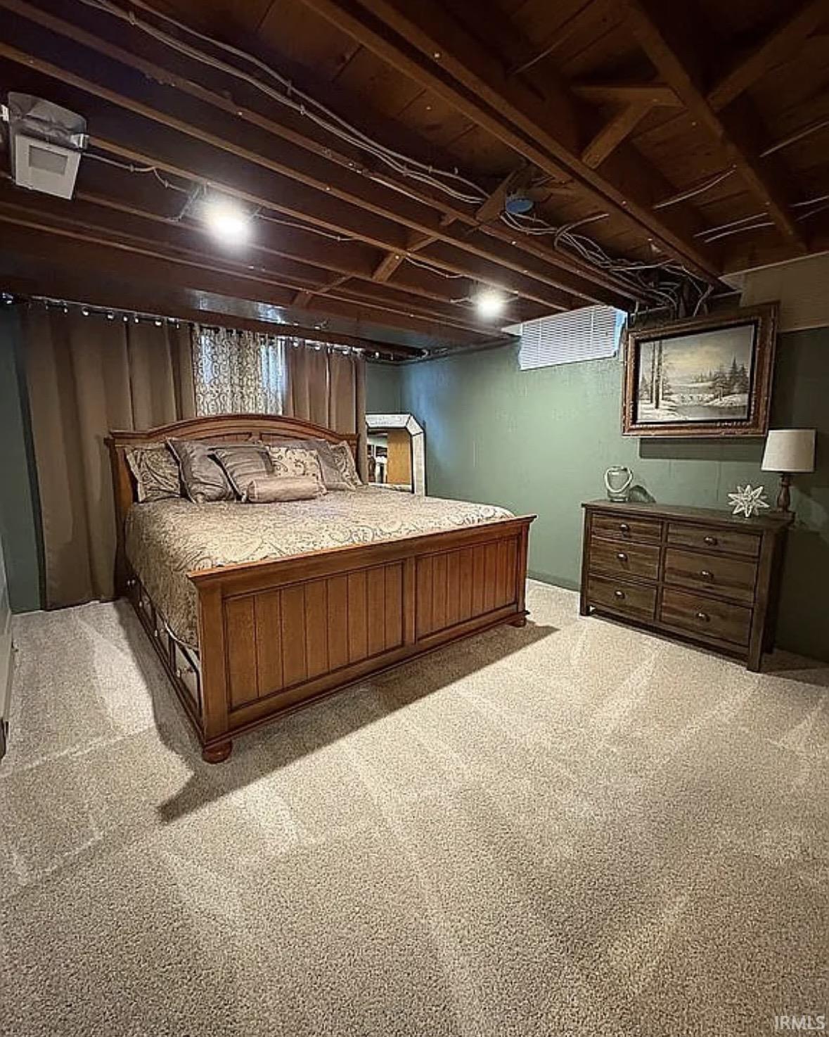 Carpeted room with exposed ceiling joists and recessed lighting