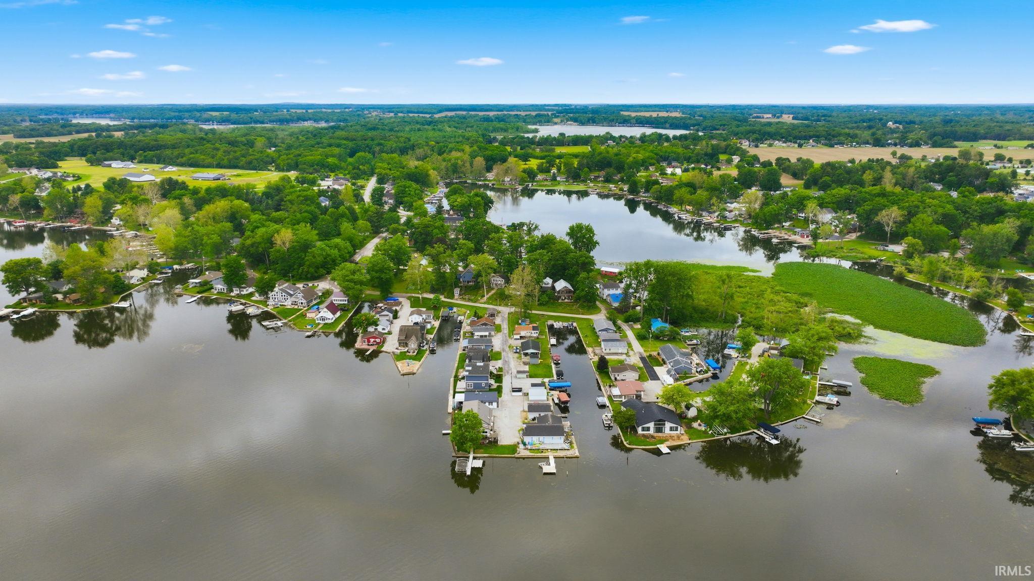 Aerial perspective featuring a freshwater lake surrounded by residential properties