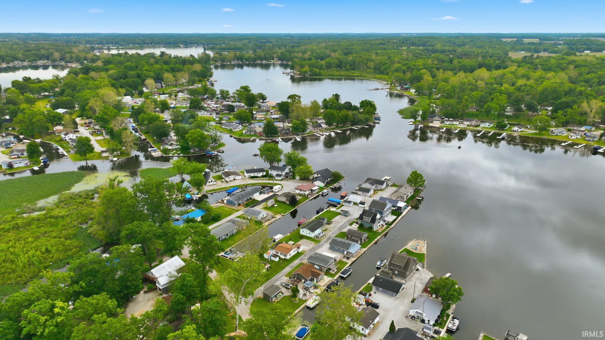 Aerial perspective showcasing a residential area interspersed with multiple bodies of water and abundant green foliage