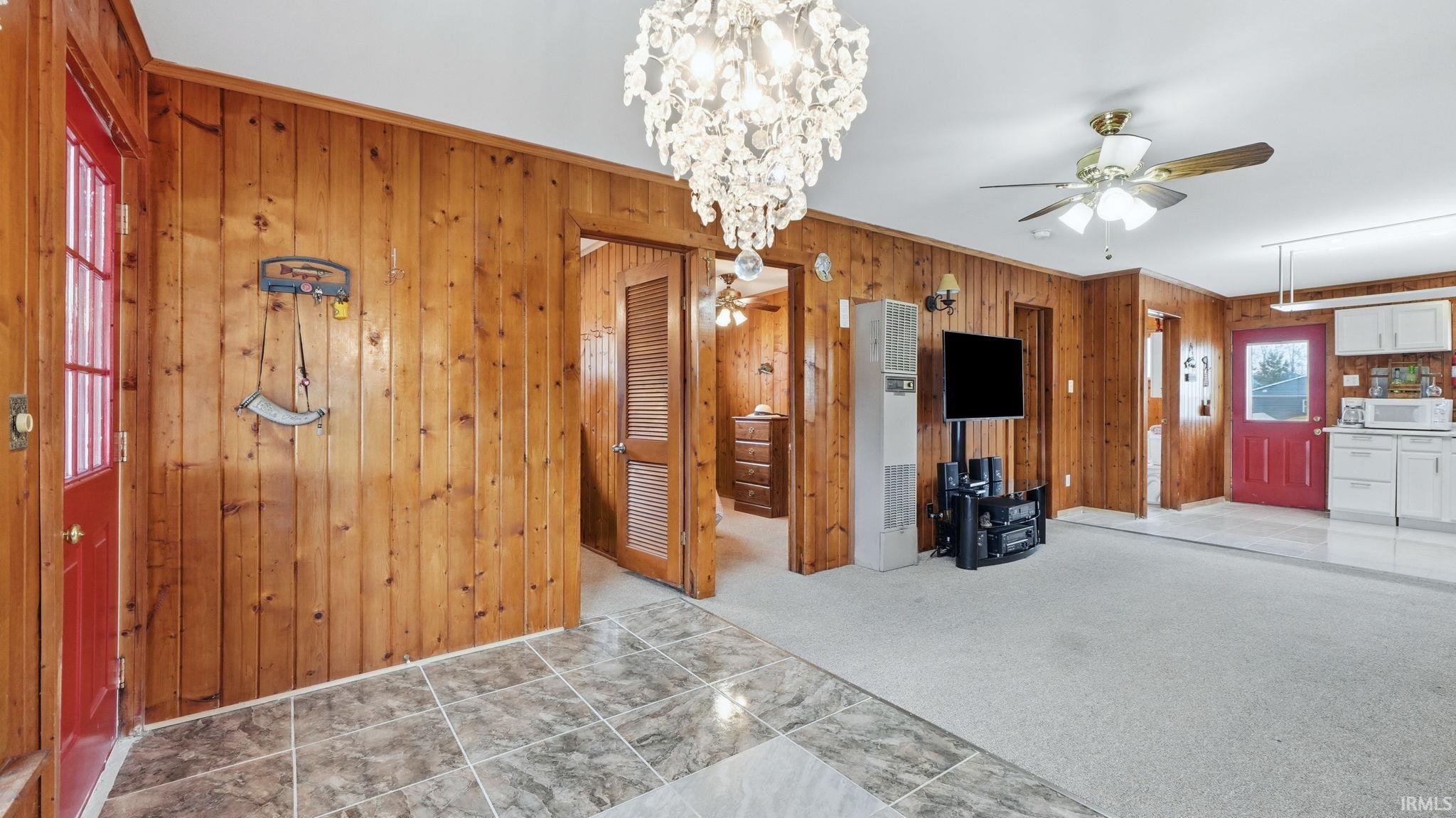 Wood-paneled interior with a crystal chandelier and recessed lighting