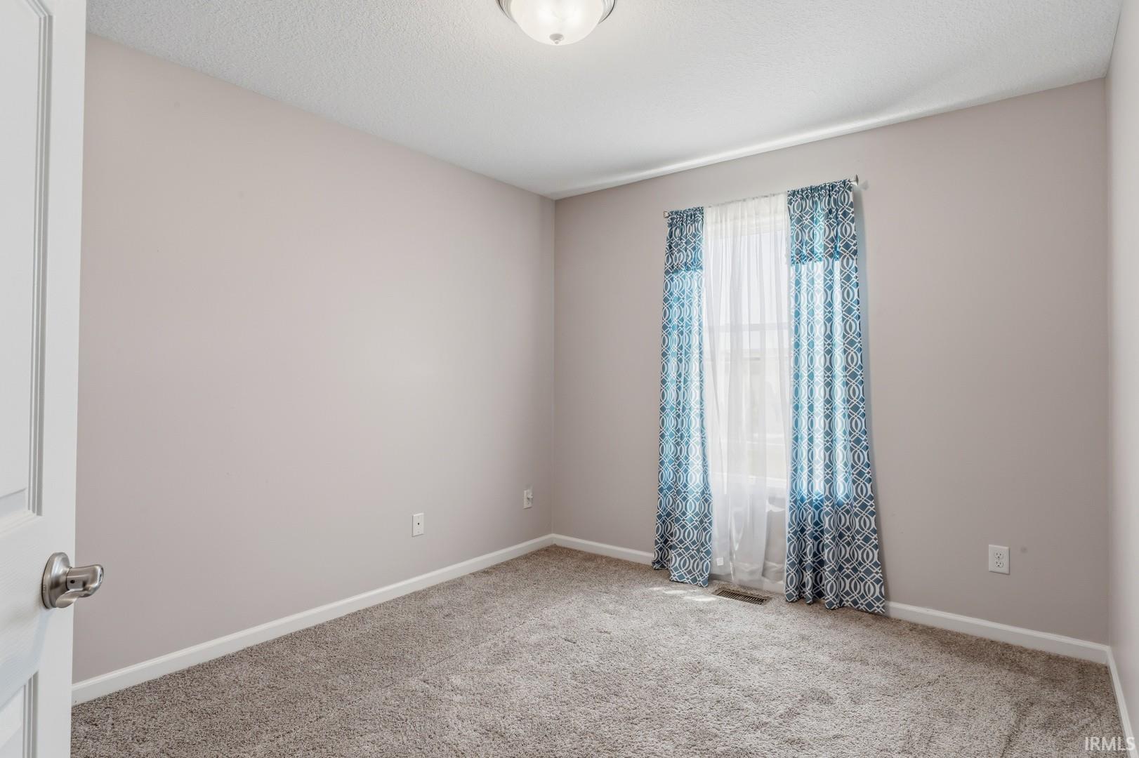 Neutral wall paint and textured carpeting