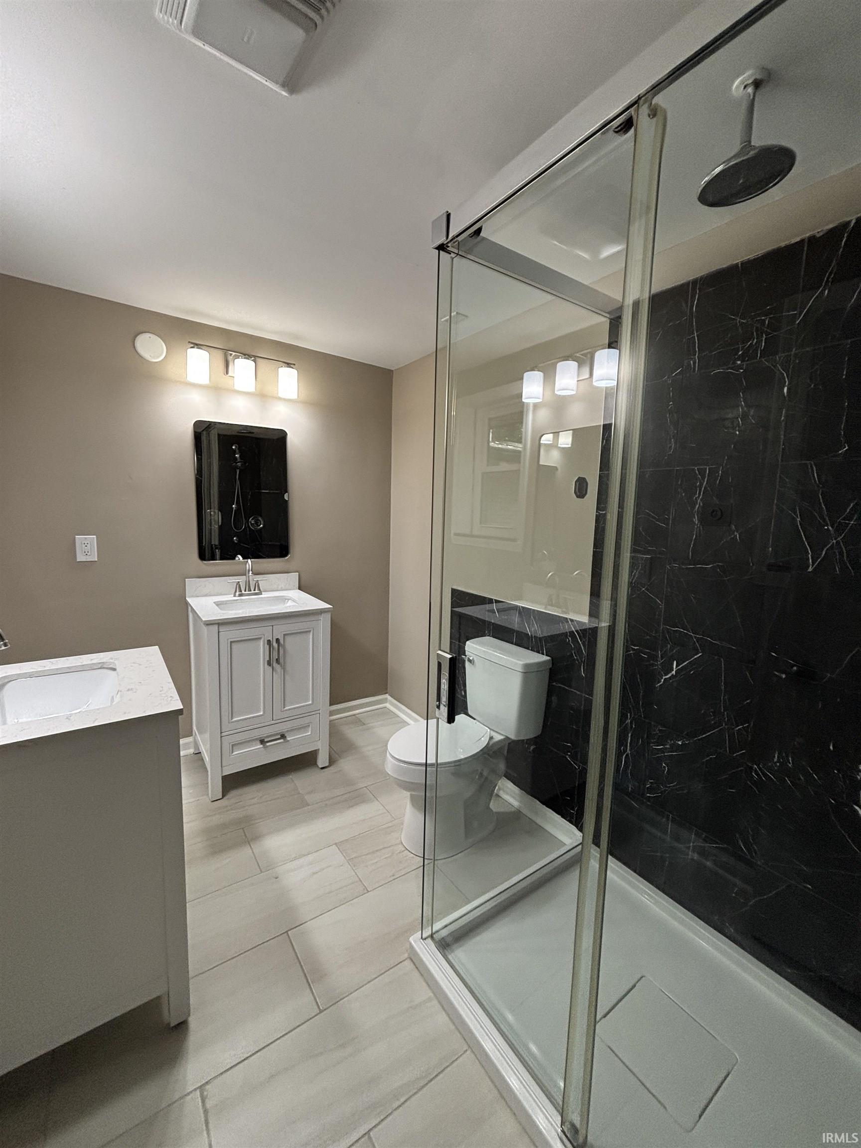 Contemporary bathroom featuring a spacious glass-enclosed shower with black marble-patterned wall tile and a rainfall showerhead