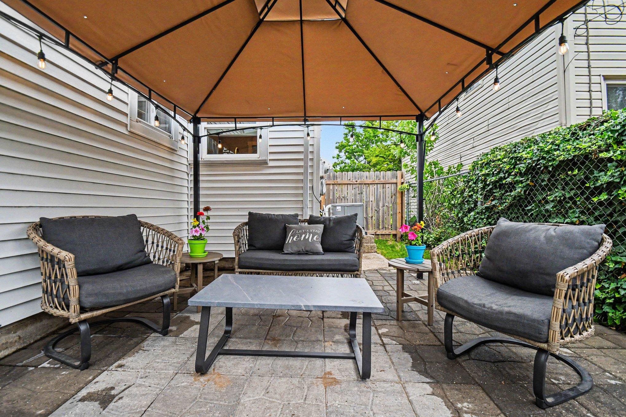 Paved patio area featuring a covered gazebo structure