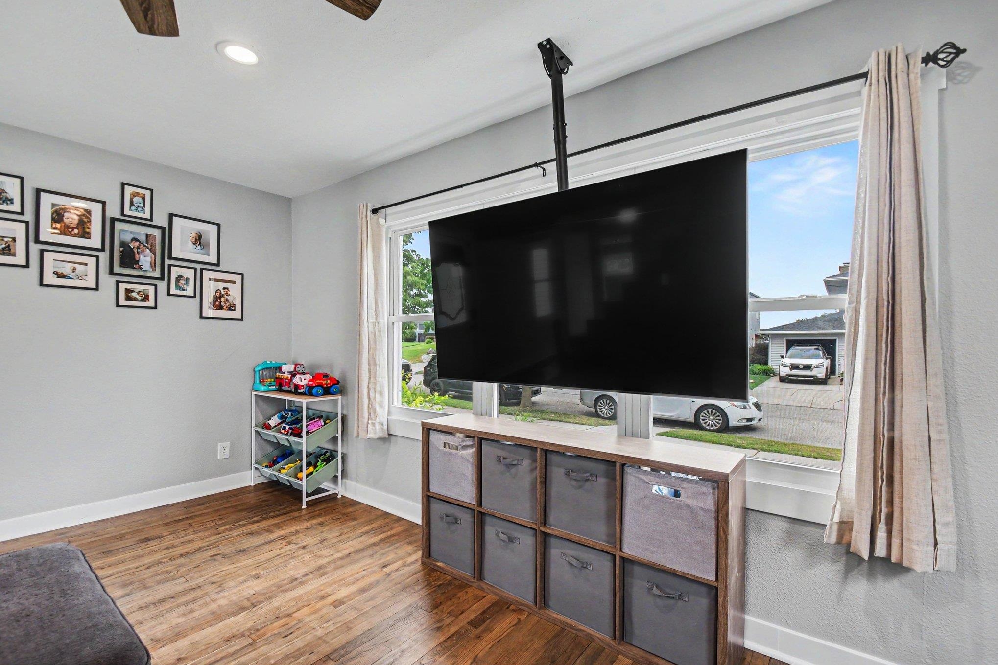 Living space featuring wood-finish flooring, light gray walls, and recessed lighting