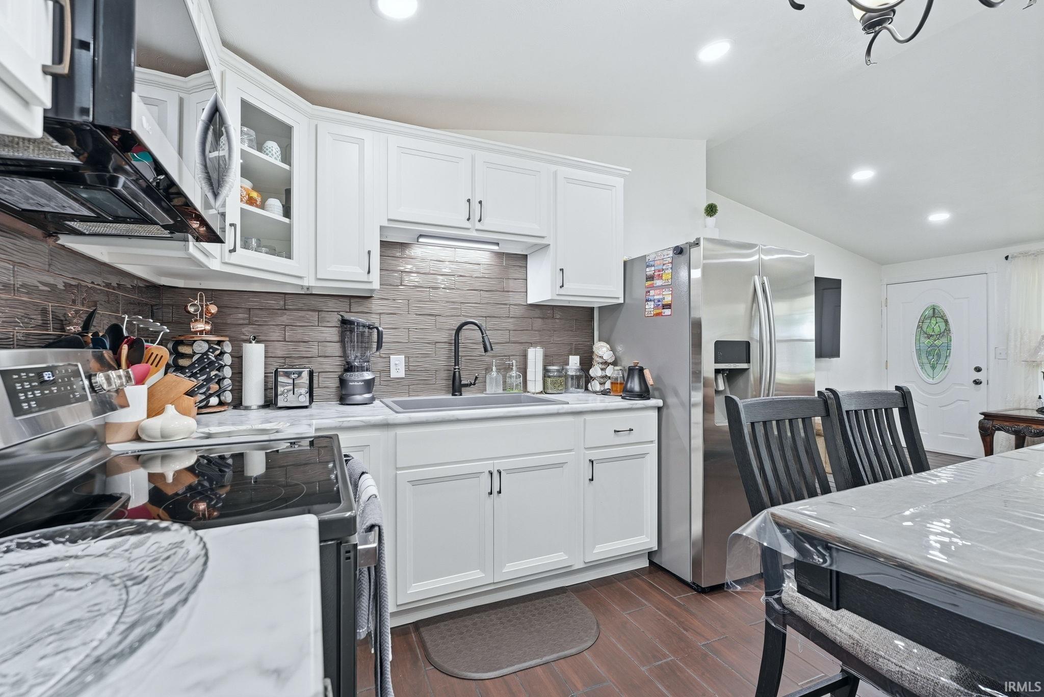 Modern kitchen with white cabinetry and stainless steel appliances