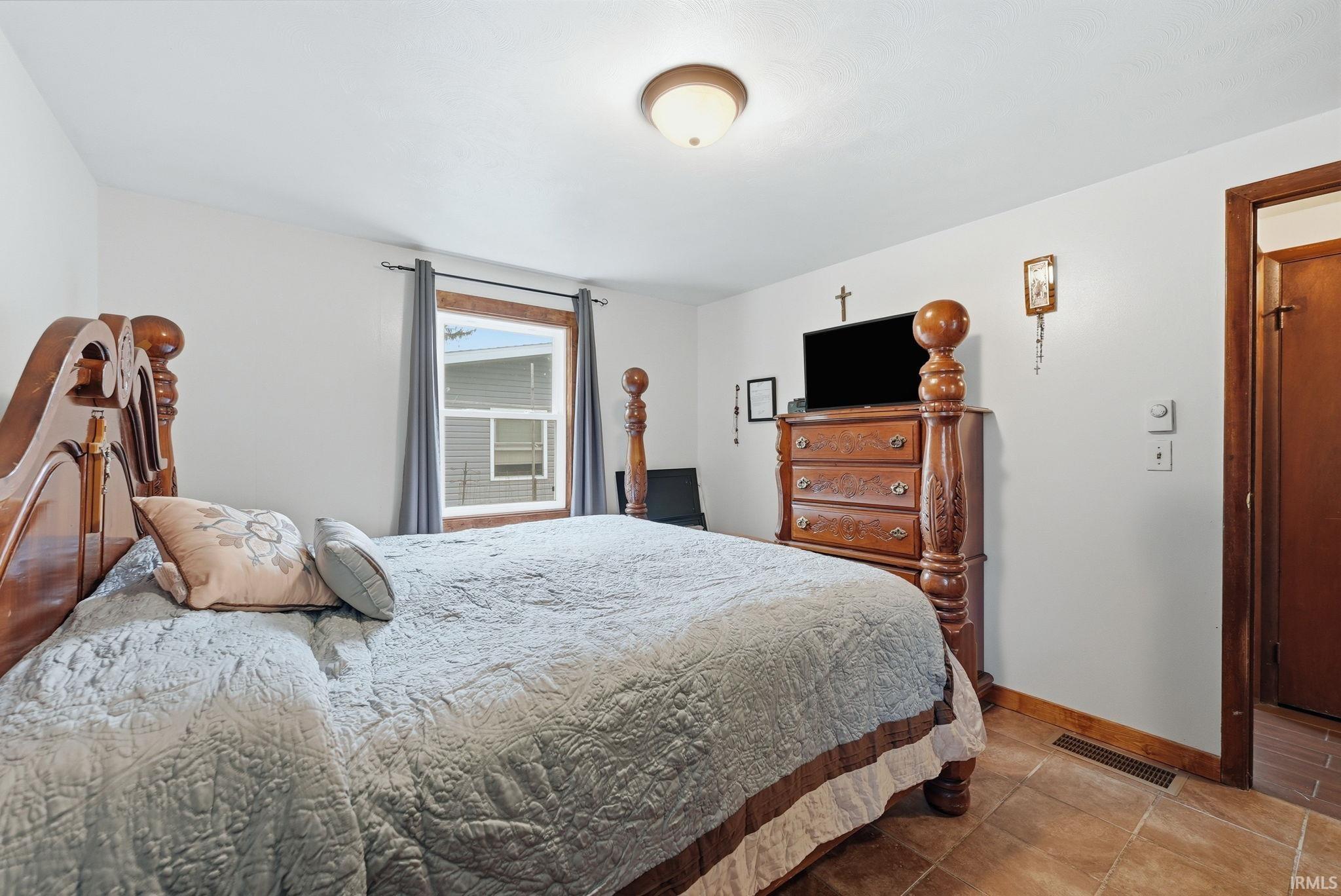 Recessed window with wood trim, ceramic tile flooring, and overhead lighting