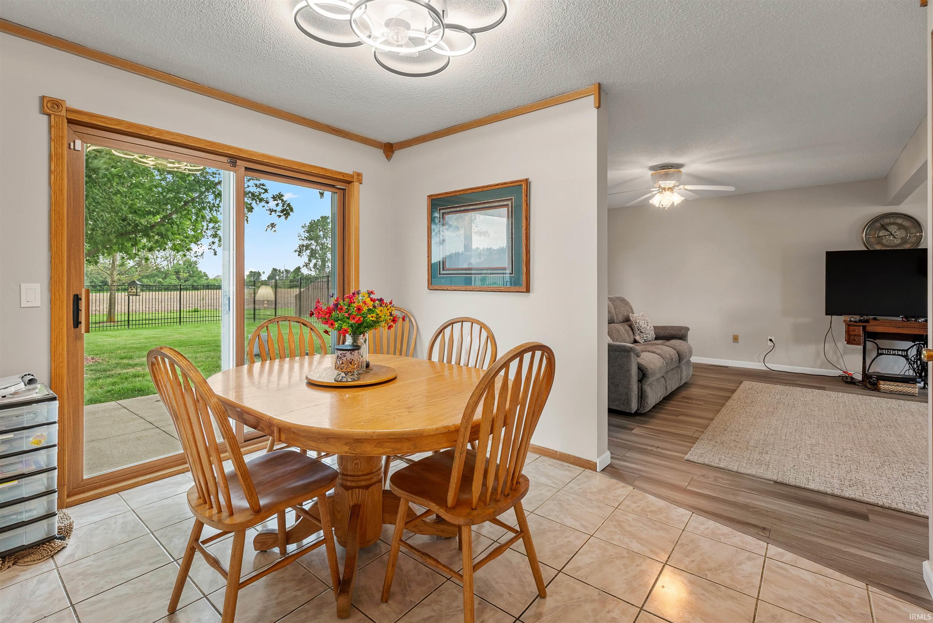 Dining area featuring light-toned tile flooring and a decorative ceiling light fixture