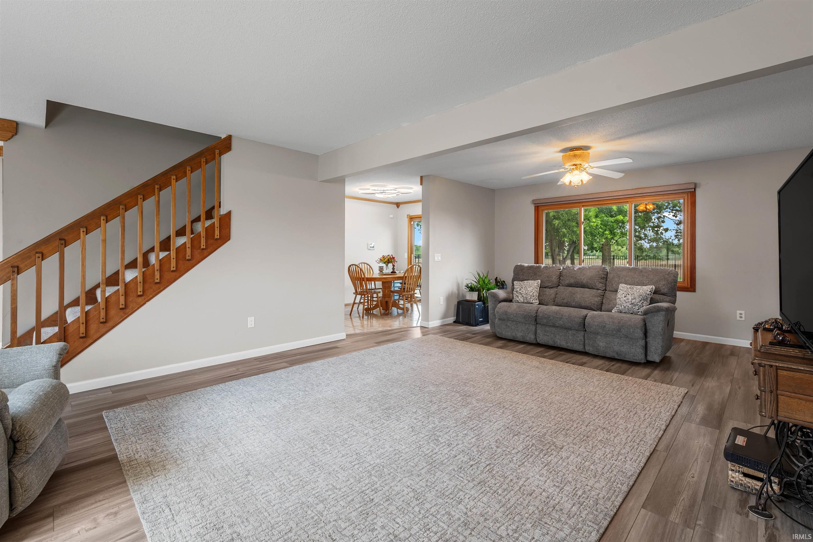 Spacious living area featuring wood-finish flooring and a neutral color palette
