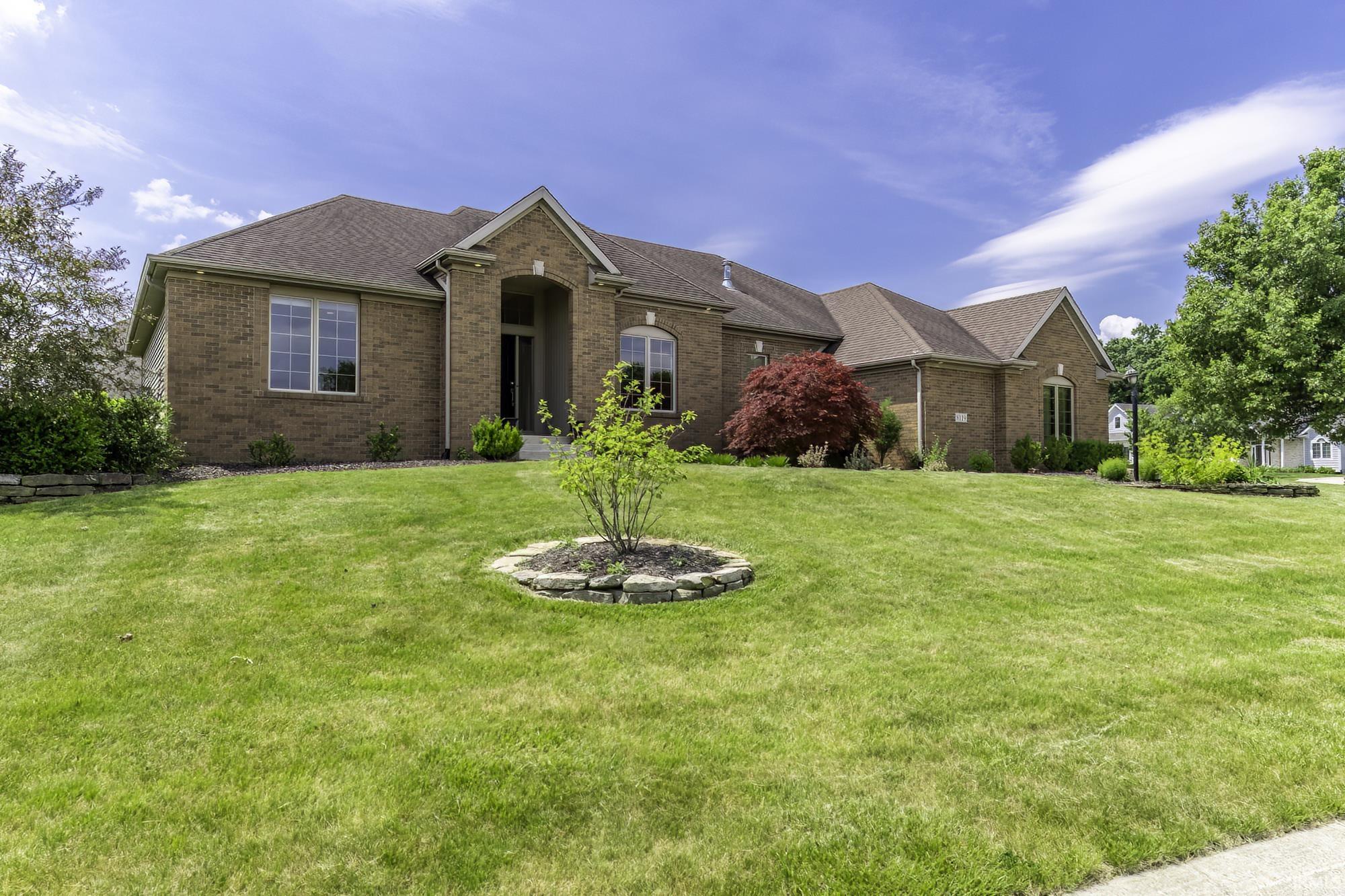Brick exterior residence with a prominent gabled entry