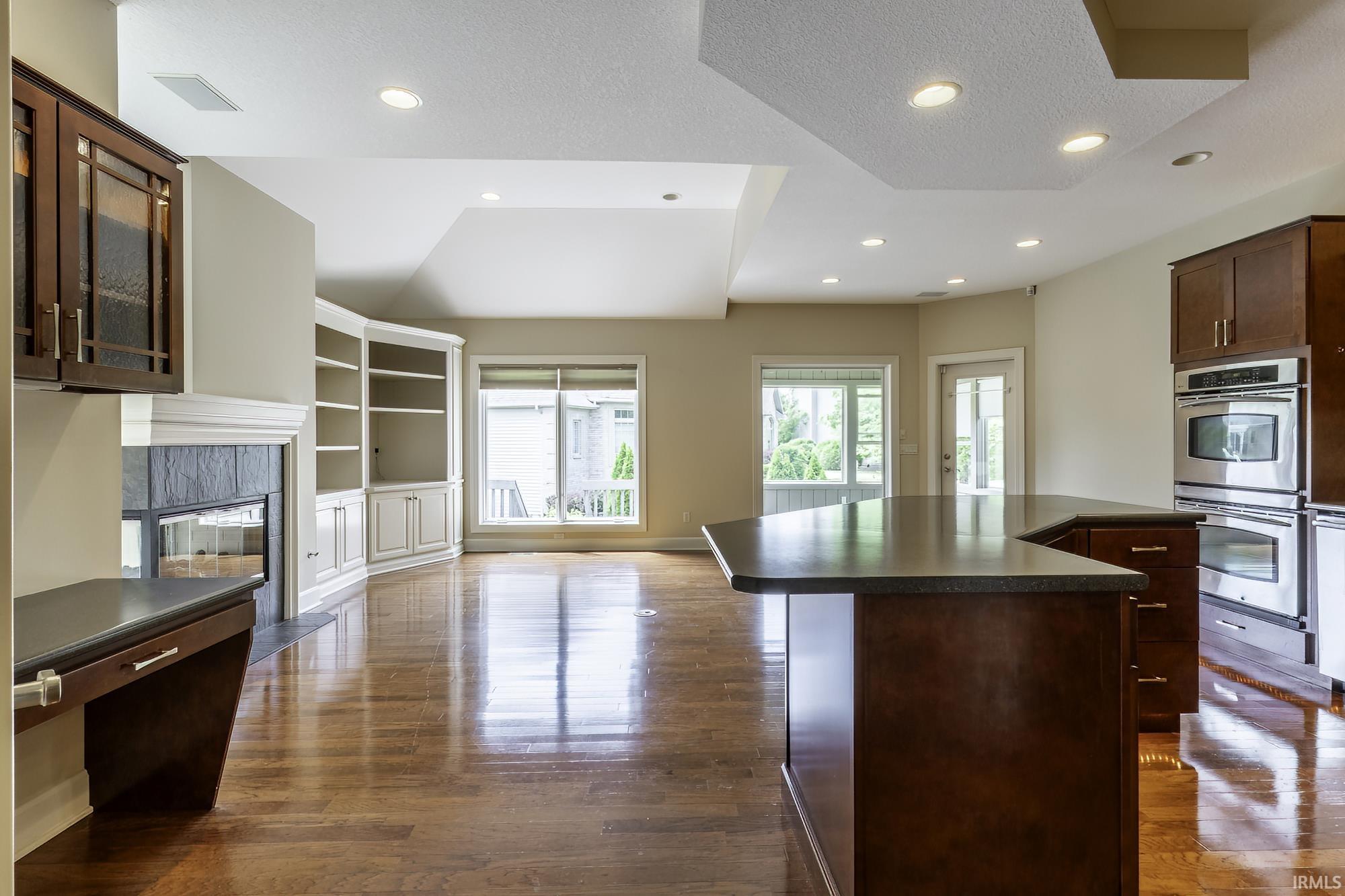 Expansive open-concept space featuring rich wood-finish flooring