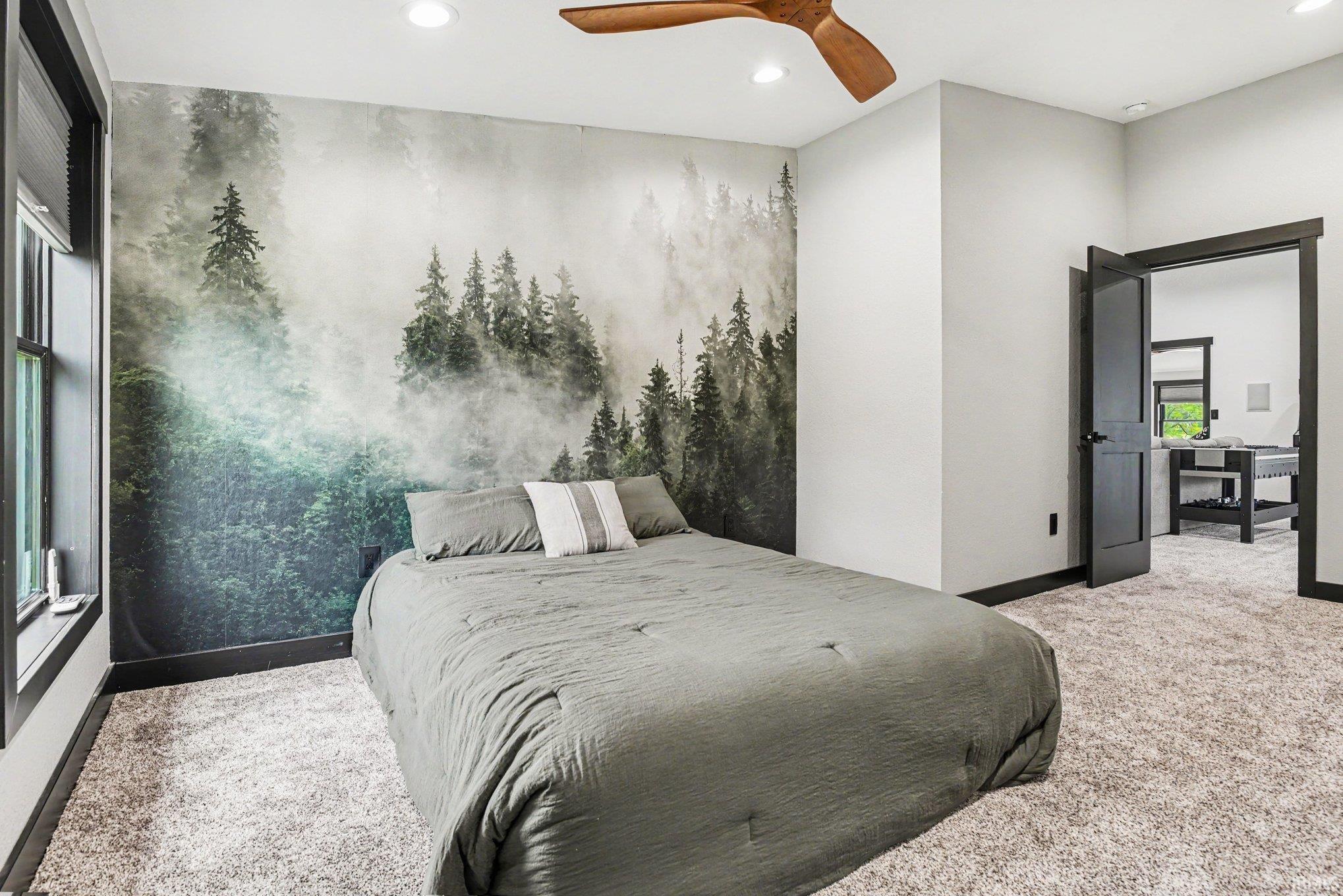 Room featuring a full wall mural, recessed lighting, and a wood-finish ceiling fan