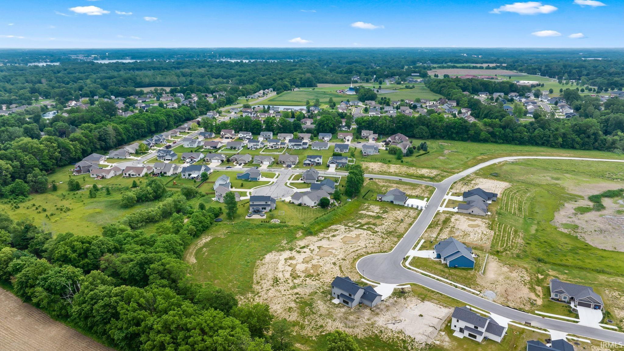 Aerial perspective showcasing a developing residential area with established homes and newly constructed properties