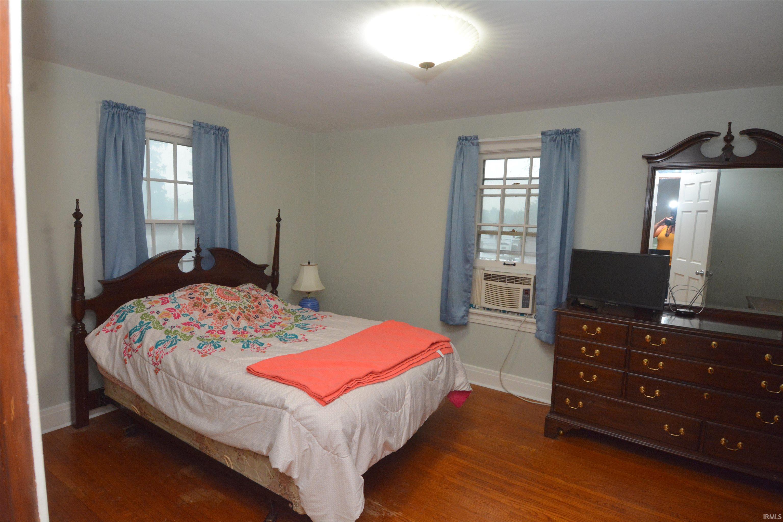 Light-colored walls complement the warm wood-finish flooring in this room