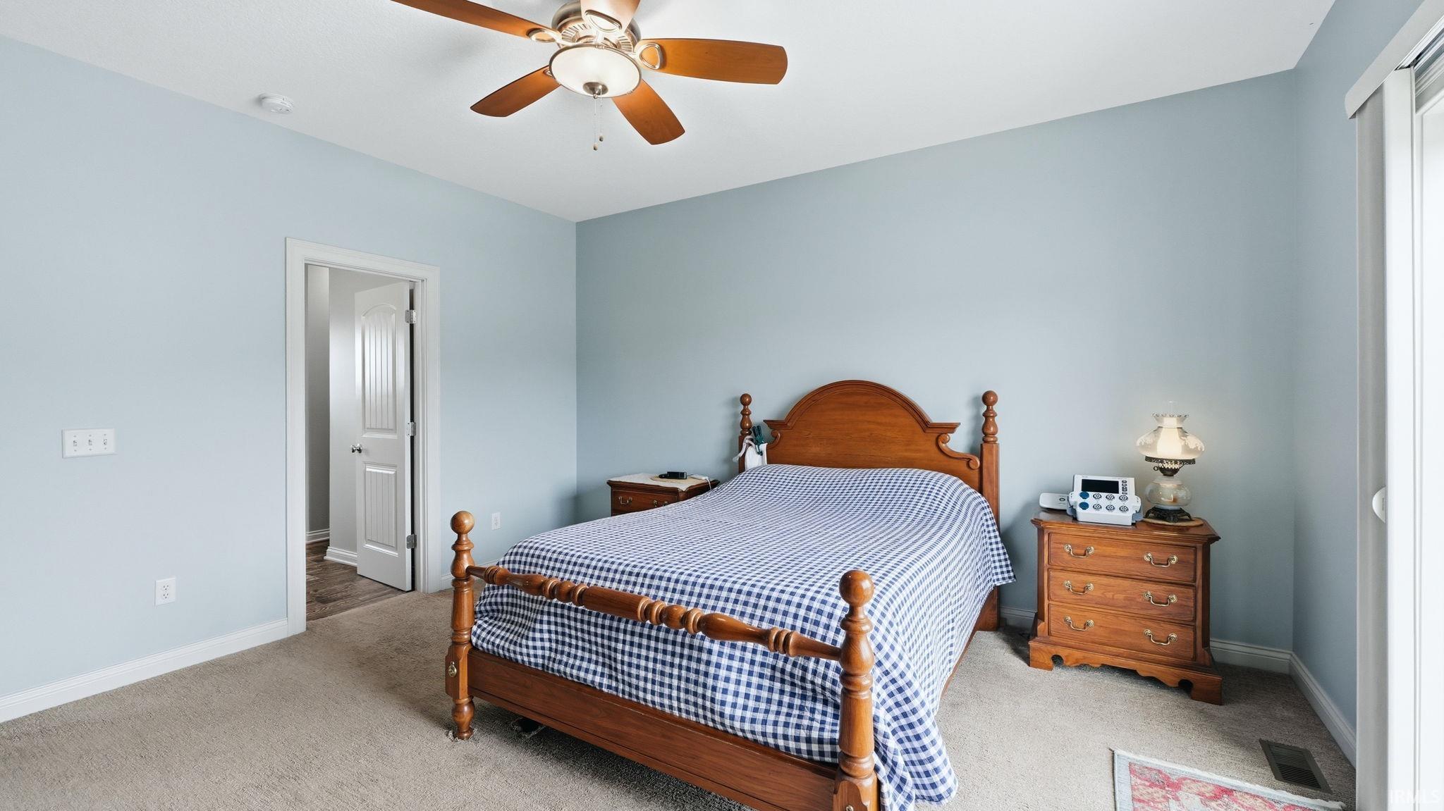 Carpeted room with light blue walls and white trim