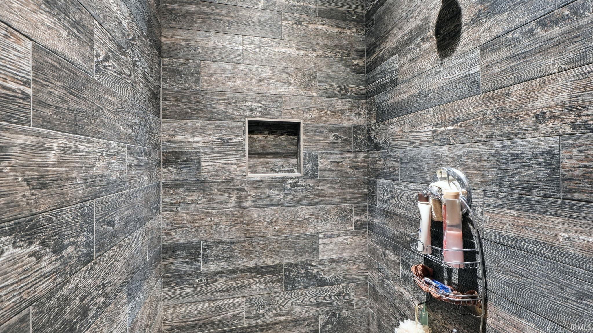 Shower enclosure featuring wood-finish tile walls