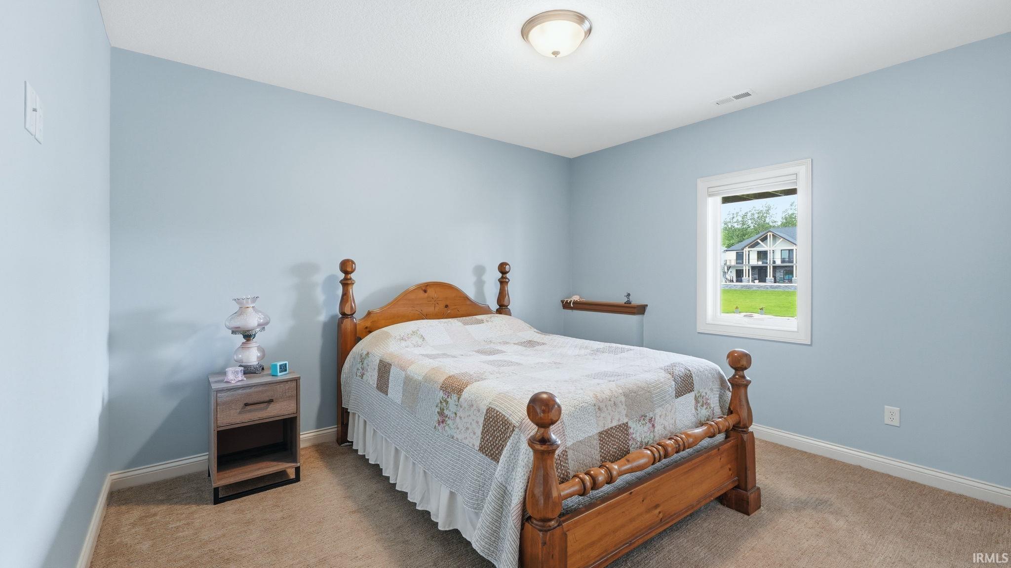 Carpeted bedroom with light blue walls and white trim