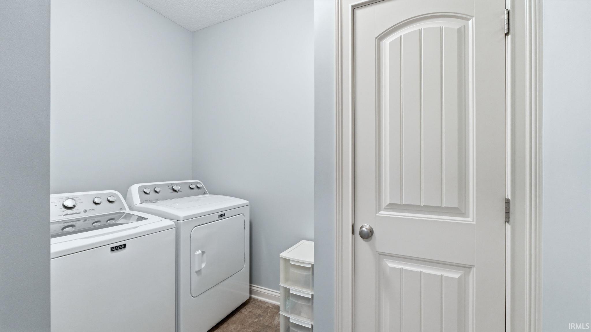 Dedicated laundry area featuring a white washing machine and dryer set