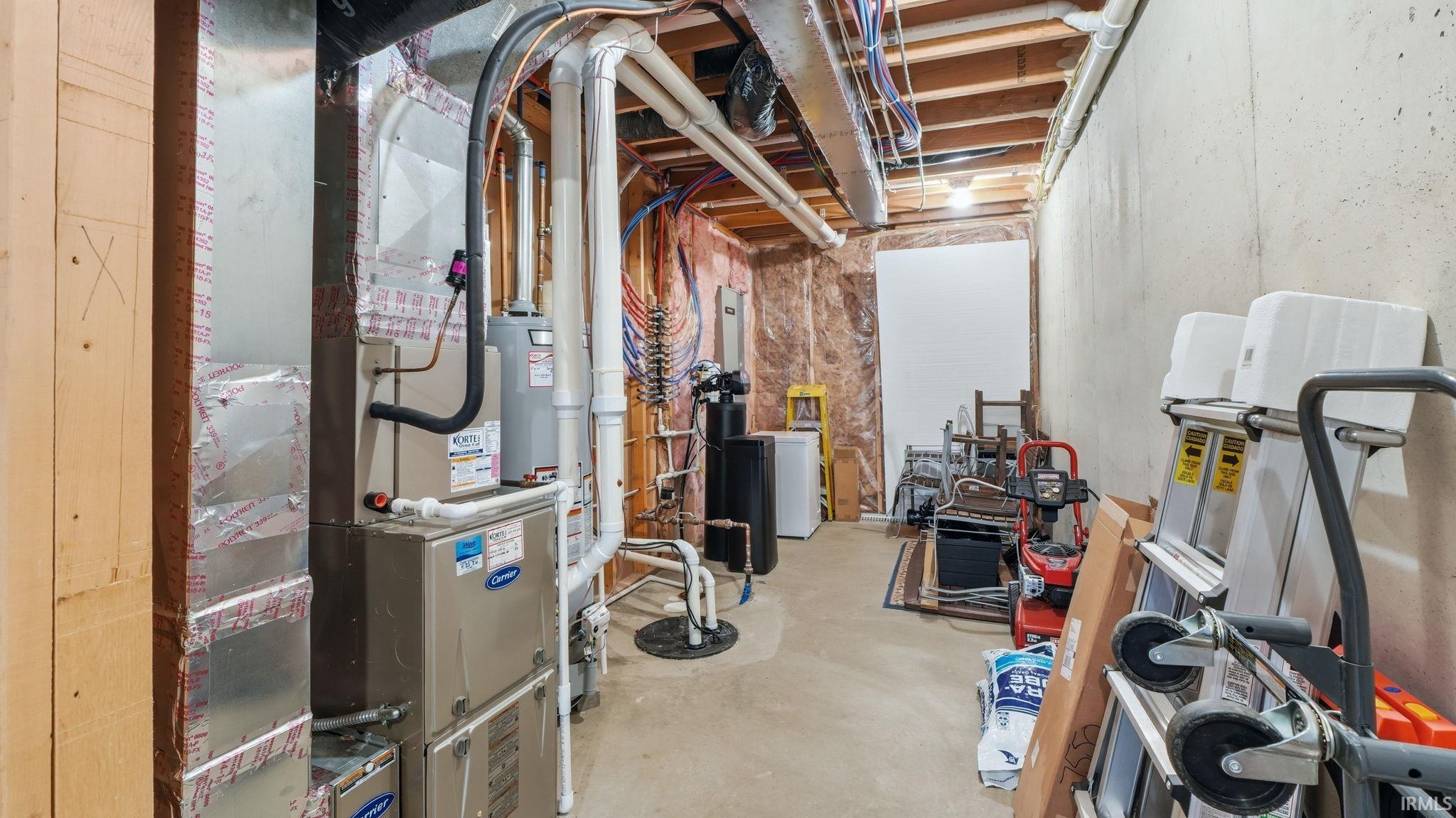 Utility room featuring a furnace, water heater, exposed ductwork, concrete flooring, and exposed ceiling joists