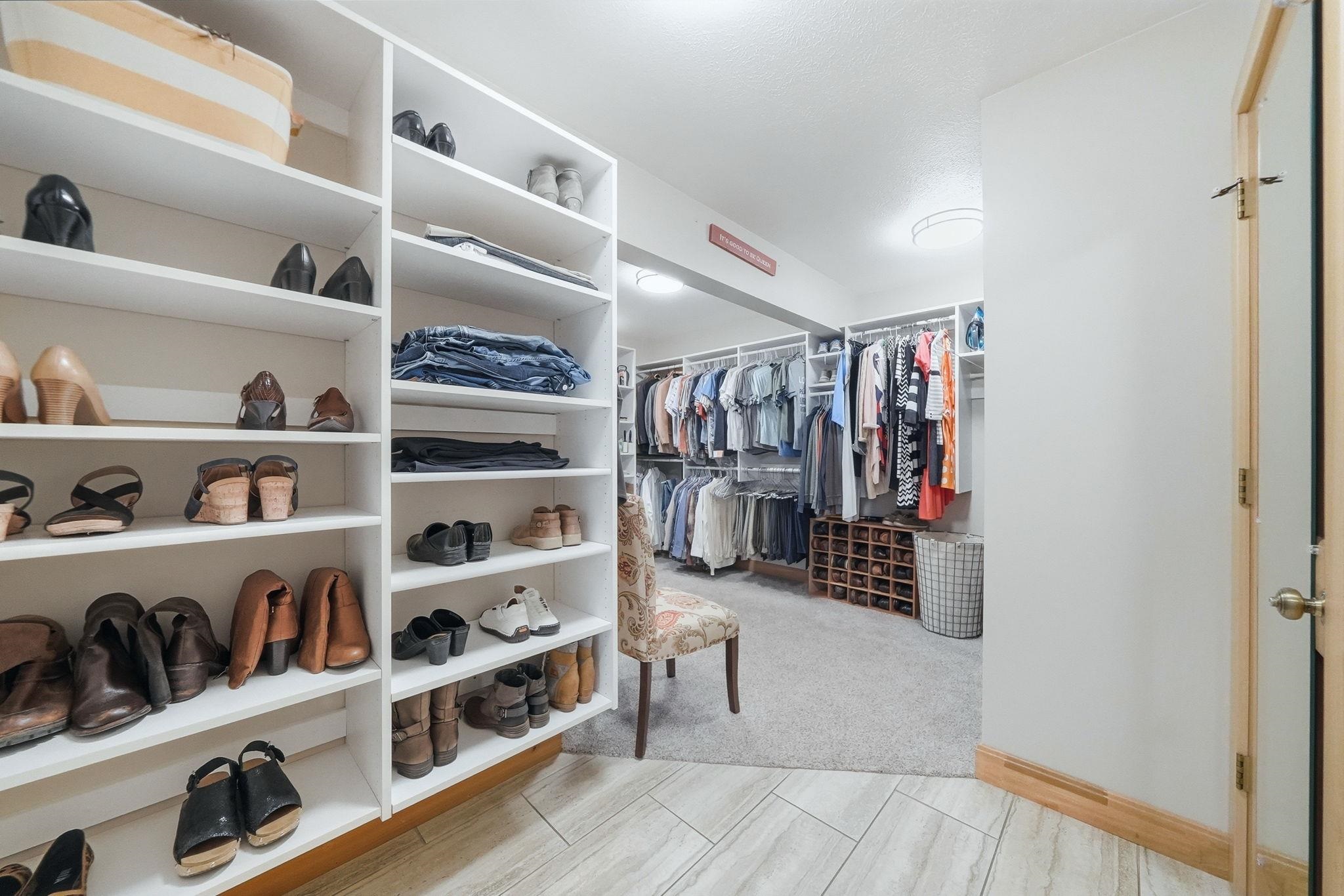 Custom closet system featuring extensive shelving and hanging rods
