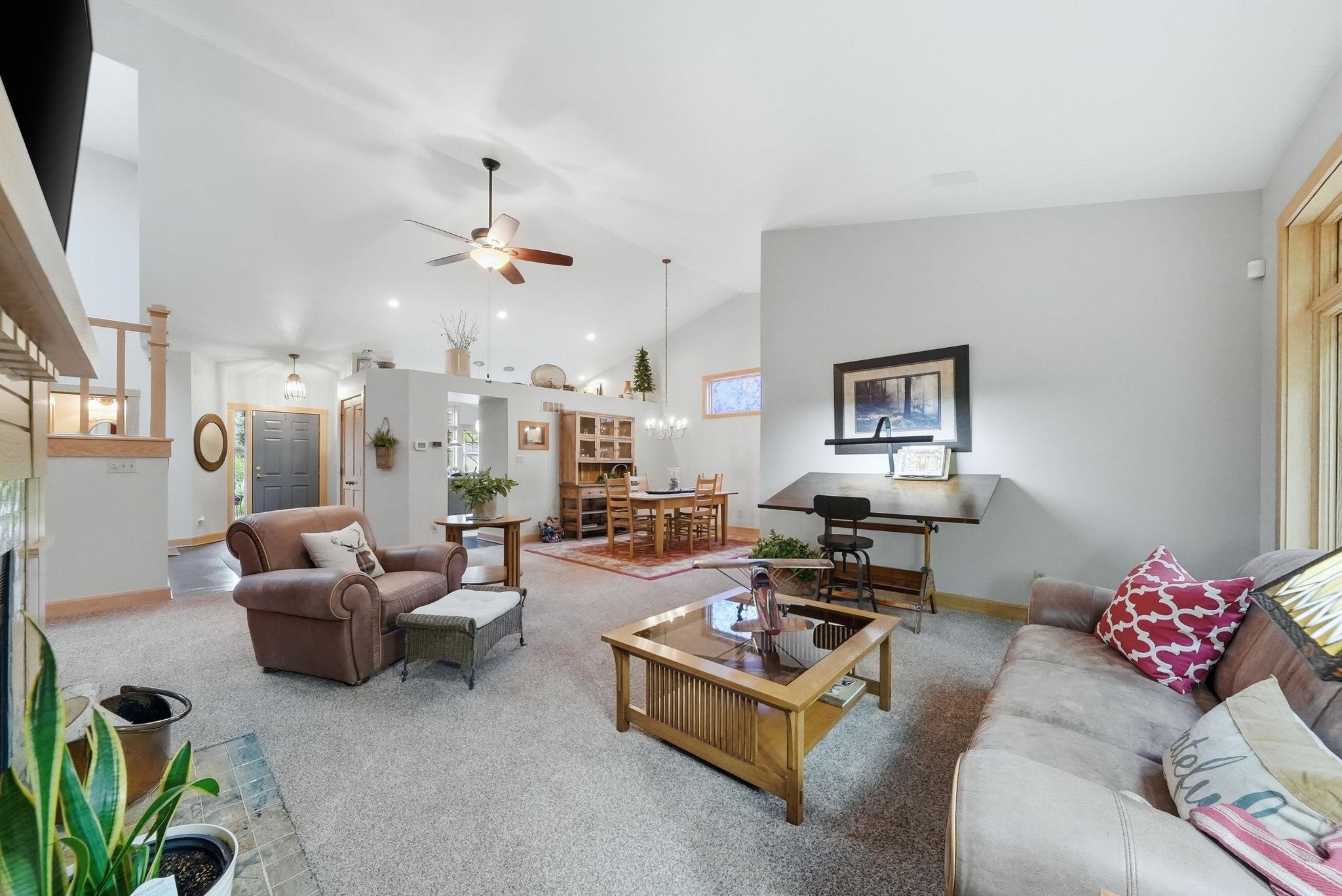Vaulted ceilings and recessed lighting define this spacious living area