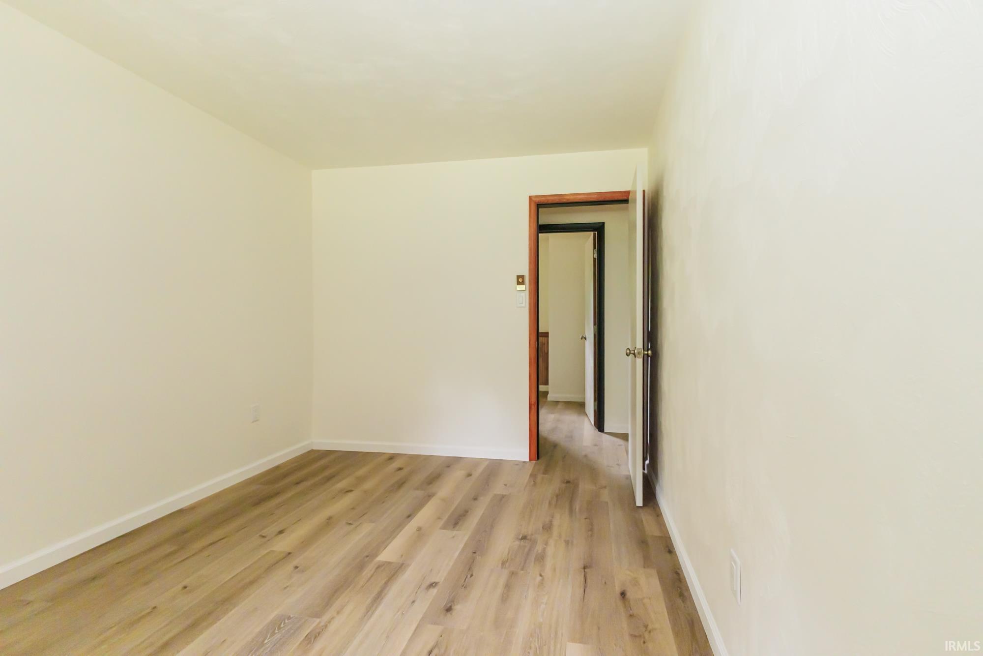 Light-toned wood-finish flooring provides a neutral palette to this interior space