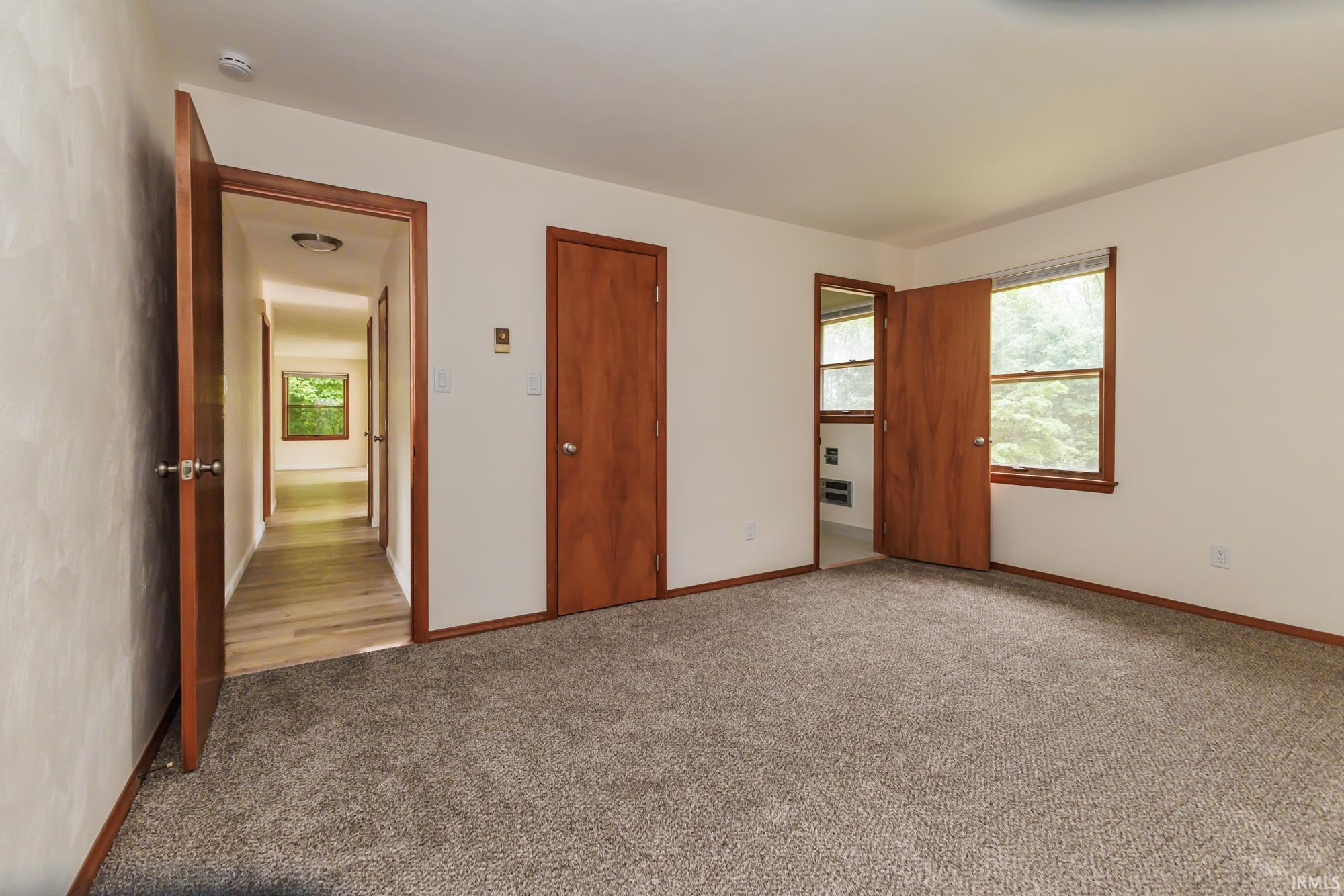 Room featuring neutral-toned carpeting and light-colored walls