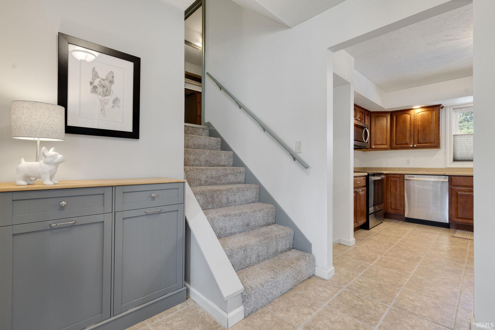 Carpeted staircase with wall-mounted handrail