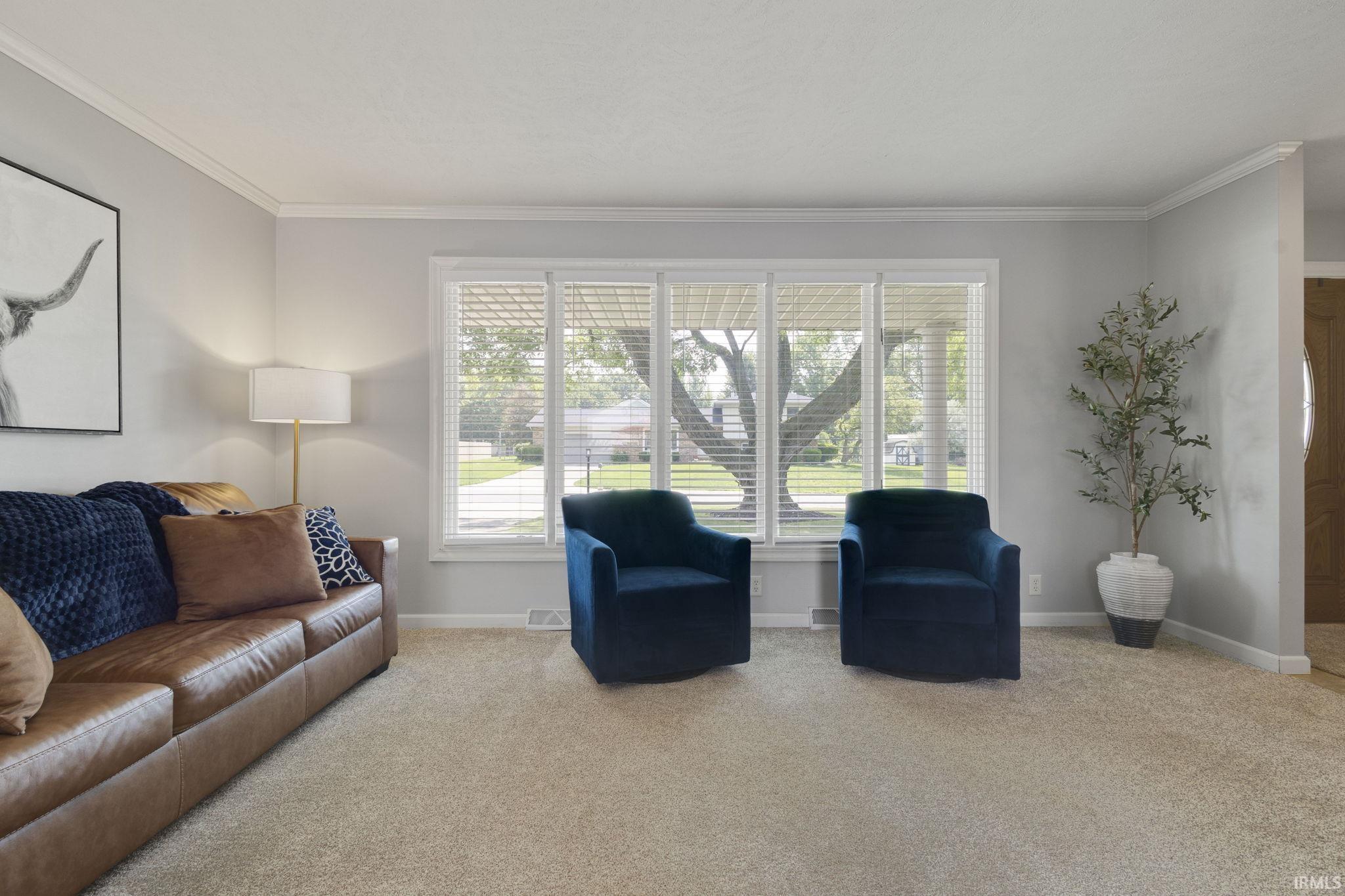 Living area featuring a large window with white blinds