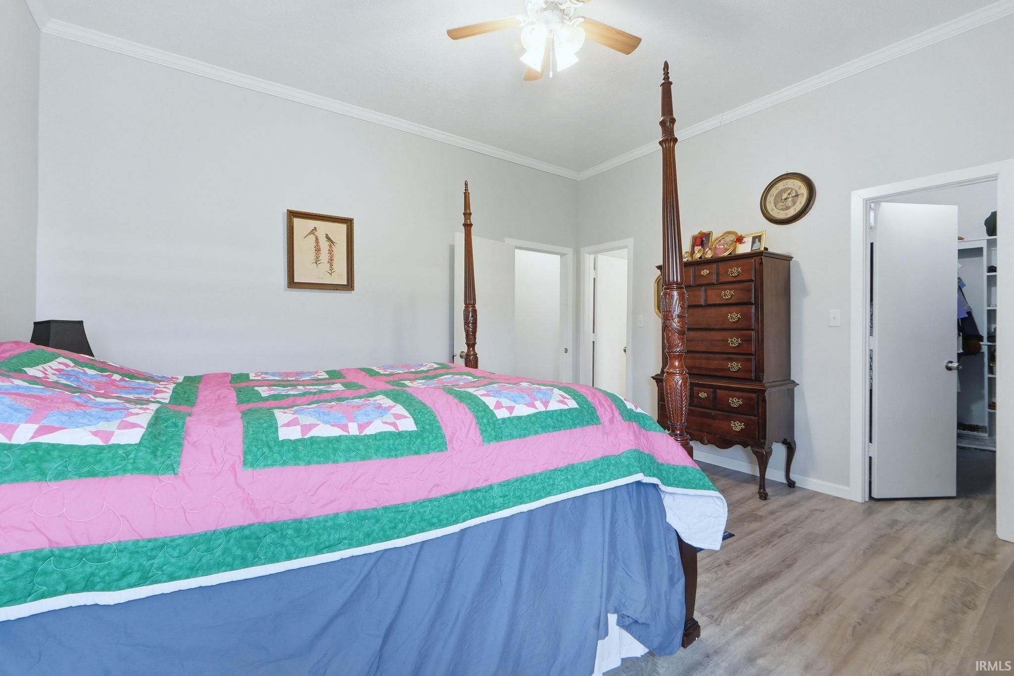 Bedroom featuring light gray wall paint and wood-finish flooring
